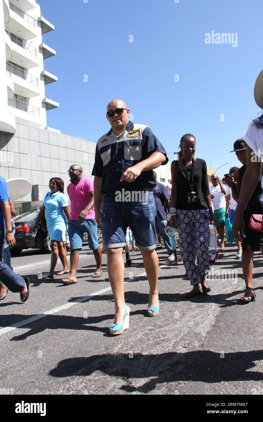 (140308) -- WINDHOEK, March 8, 2014 (Xinhua) -- A man wearing high-heels participates in a march to protest gender based violence in Namibian capital Windhoek, March 8, 2014. Dozens of men wearing high-heels participated in the Men March to Stop Gender Based Violence & Passion Killing in Namibia in Namibian capital Windhoek on Saturday. The march aims to protest the surge of fatal crimes and violence against Namibian women since the beginning of this year, during which period over ten women were killed by their male partners in the southwestern African country with a population of two million. Stock Photo
