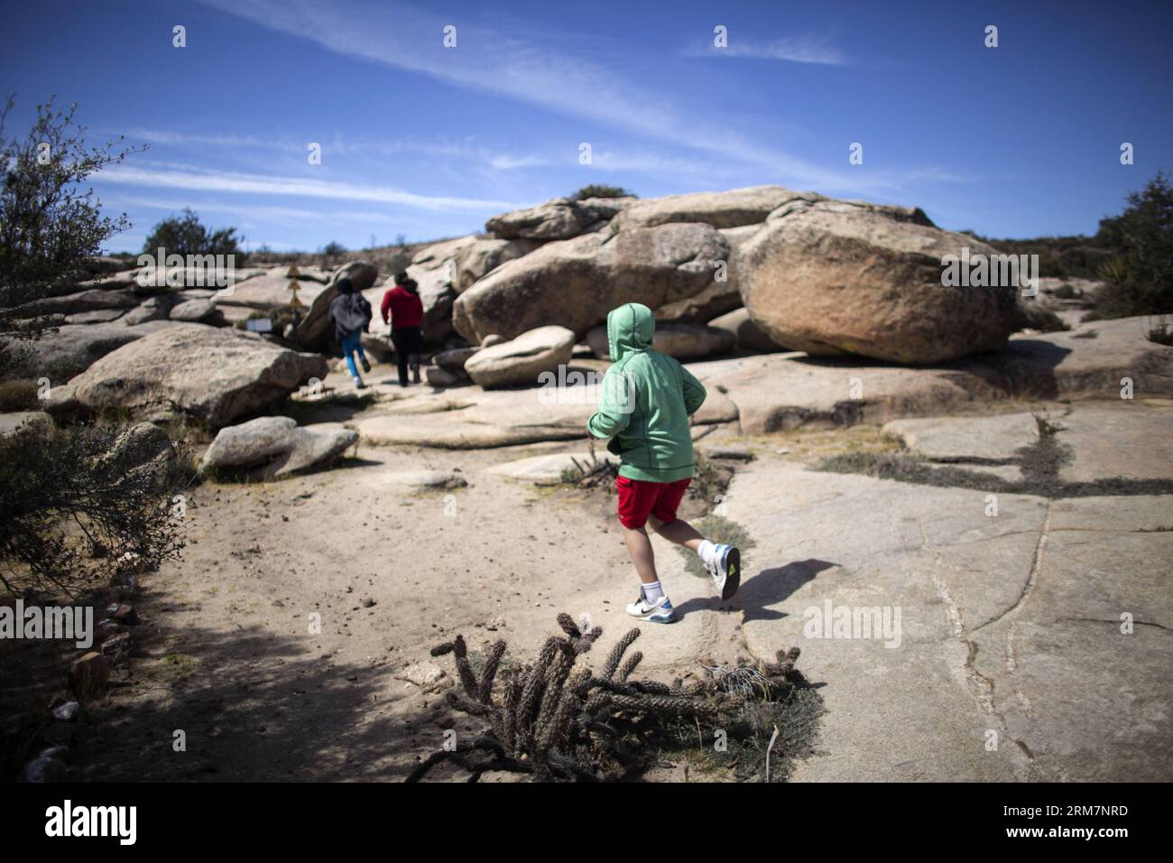 (140311) -- BAJA CALIFORNIA, (Xinhua) -- Image taken on March 9, 2014 shows tourists visiting the archaelogical site of El Vallecito near La Rumorosa town Baja California, northwest of Mexico. According to the National Institute of Antropology and History (INAH, its acronym in Spanish), El Vallecito was occupied by members of the Yuman linguistic family, which originally lived in the northwest area of the state of Baja California and southern California. At the site there are rock paintings of simple lines traced with mineral dyes in white, red, black and yellow. (Xinhua/Guillermo Arias) MEXIC Stock Photo