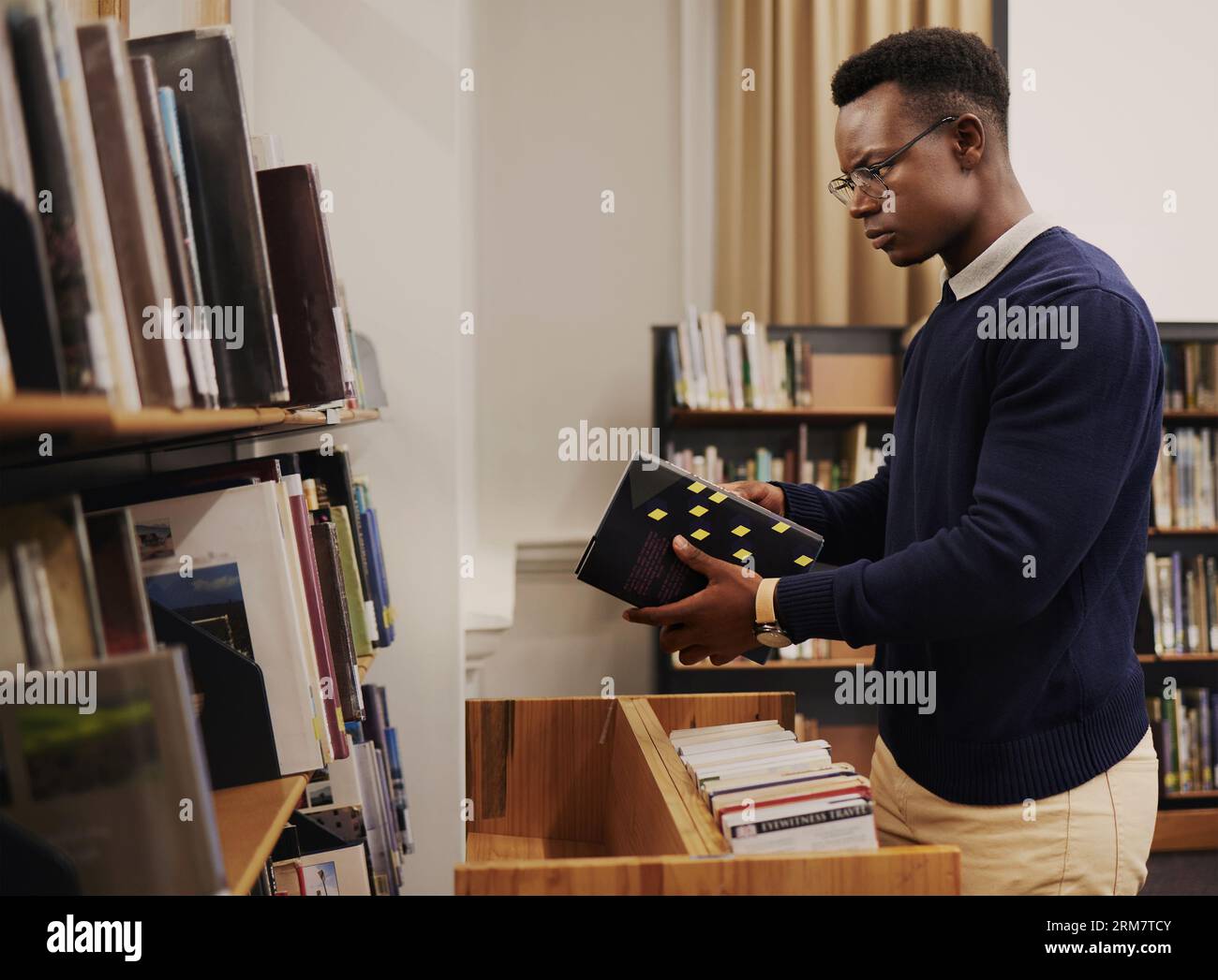 Librarian man, shelf and book with thinking, packing or stock for admin