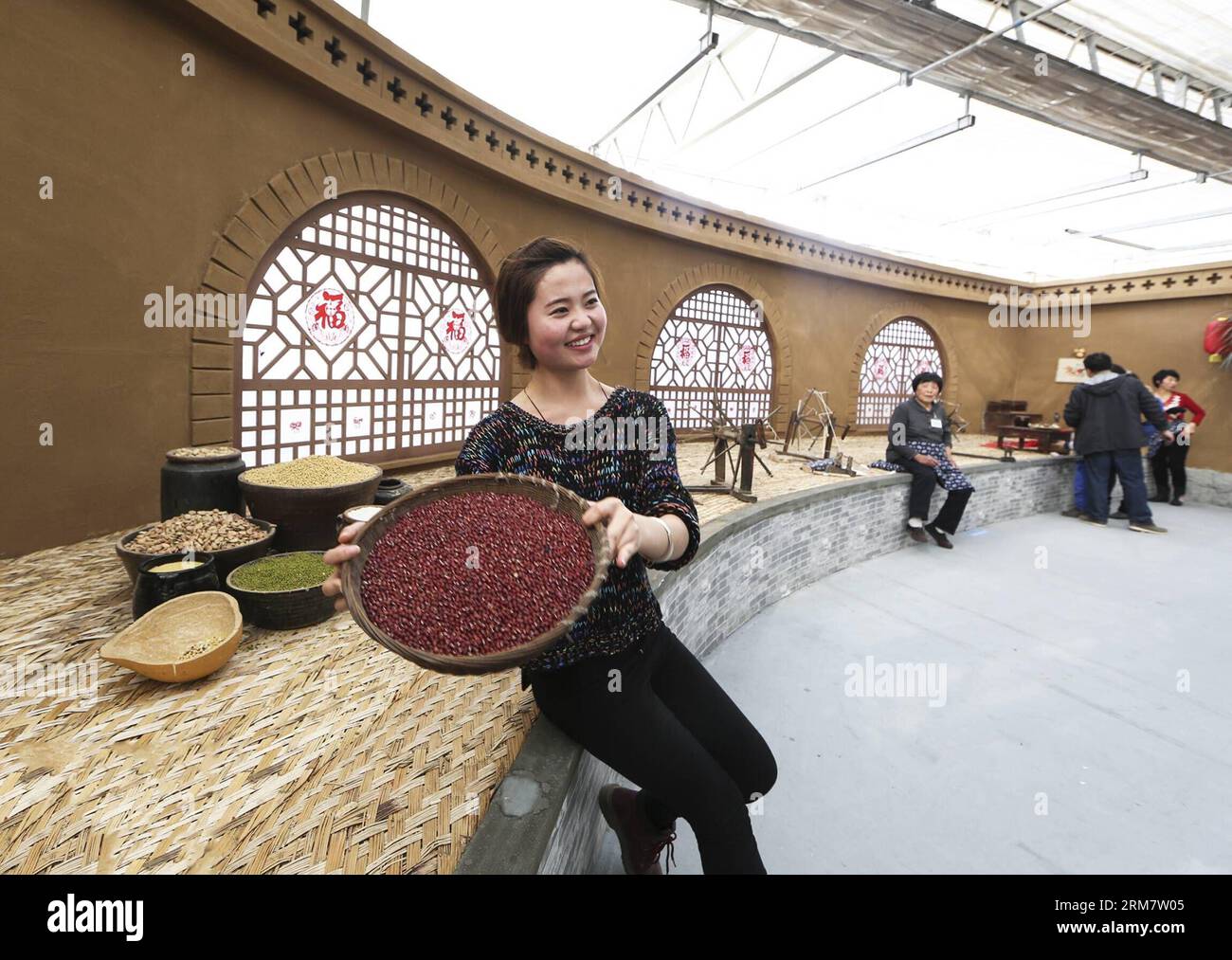 A woman poses for photos at a grain booth during the second Beijing agriculture carnival held in the Changping district of Beijing, capital of China, March 15, 2014. More than 500 new species of agricultural products were presented during the carnival, which kicked off on Saturday. (Xinhua/Li Hui) (wyo) CHINA-BEIJING-AGRICULTURE CARNIVAL (CN) PUBLICATIONxNOTxINxCHN   a Woman Poses for Photos AT a Grain Booth during The Second Beijing Agriculture Carnival Hero in The Chang Ping District of Beijing Capital of China March 15 2014 More than 500 New Species of Agricultural Products Were presented d Stock Photo