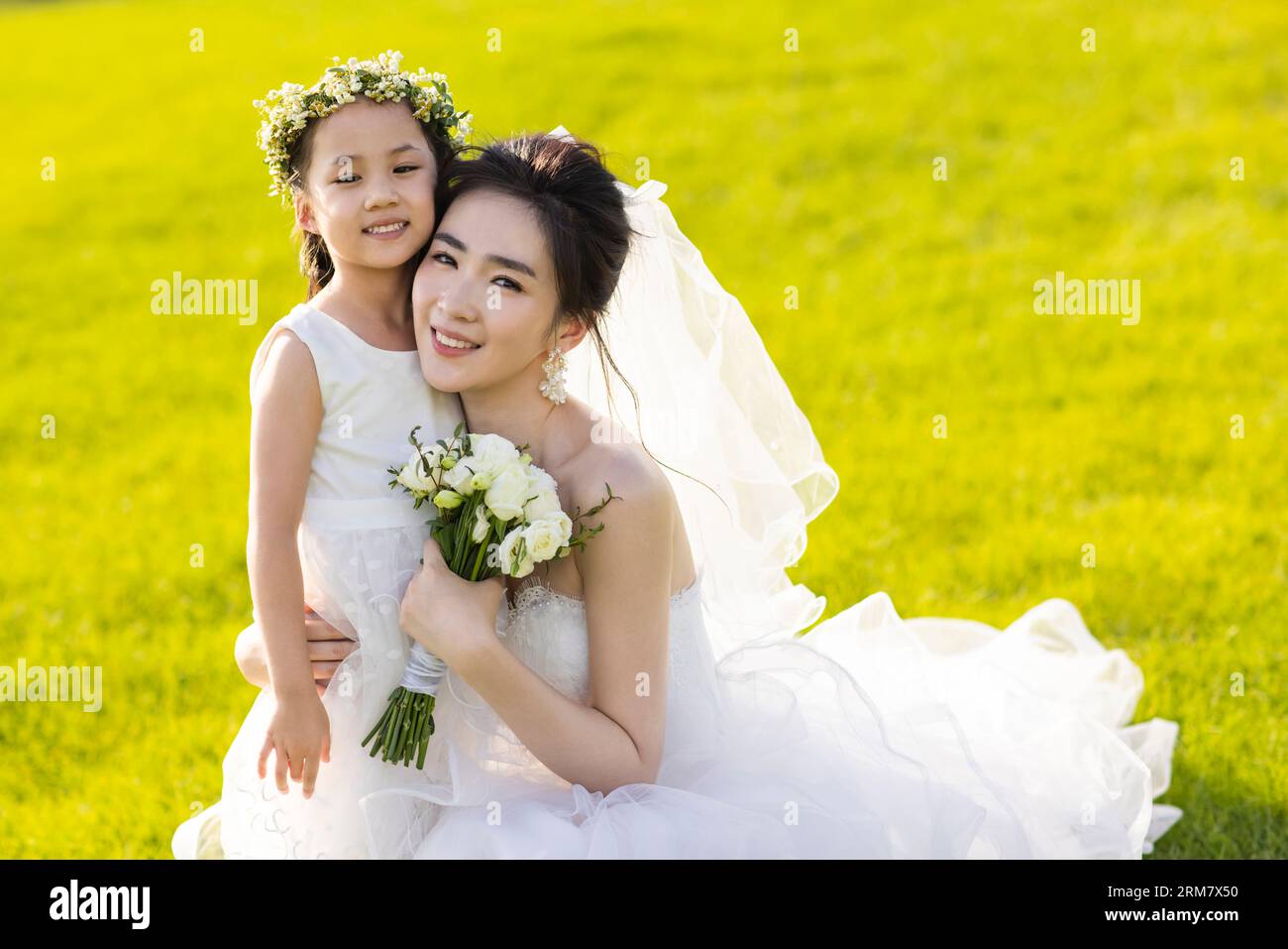 Beautiful bride with flower girl Stock Photo