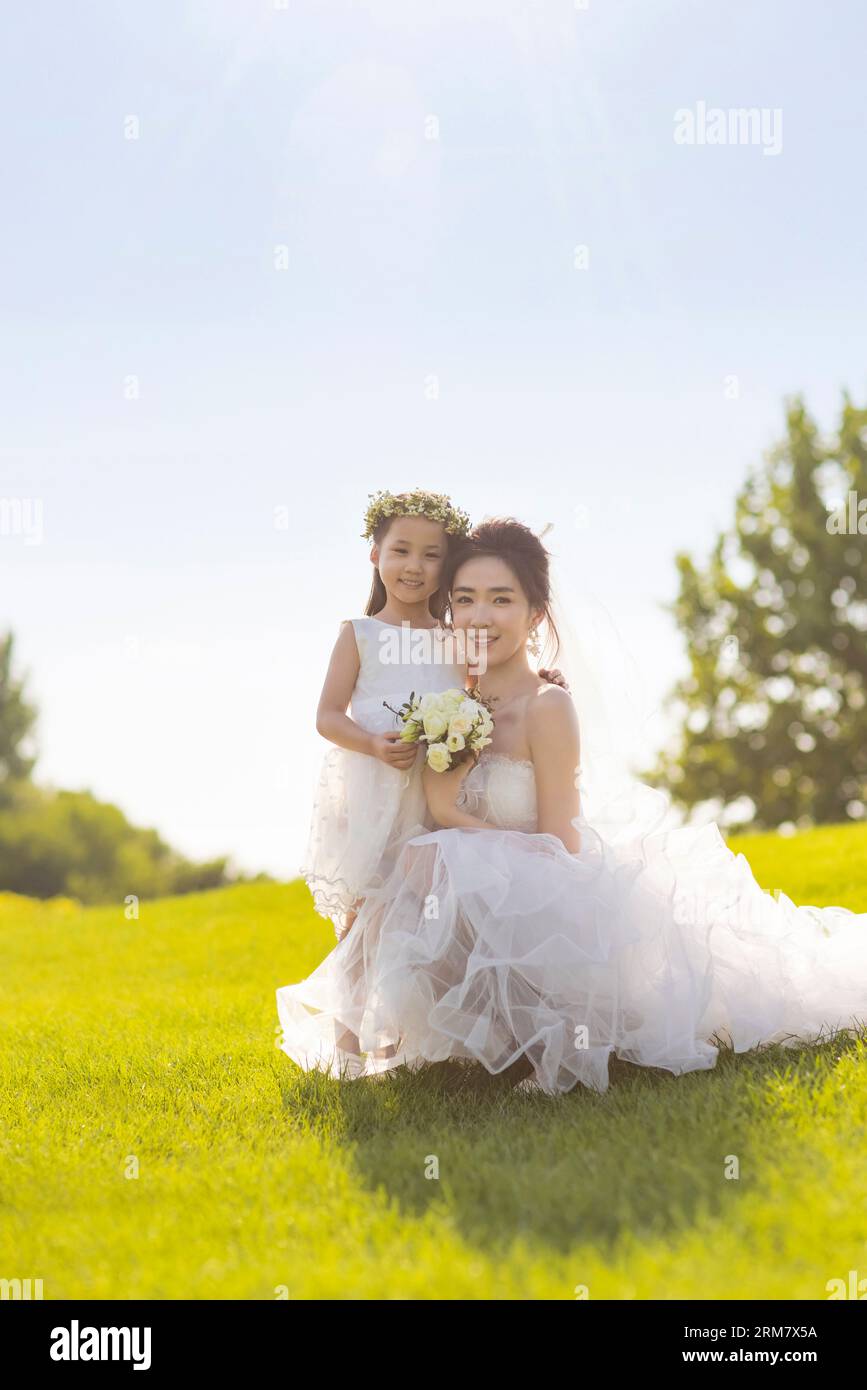 Beautiful bride with flower girl Stock Photo