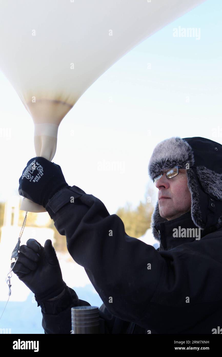 A researcher prepares for launching a sounding balloon in Sodankyla, Finland on March 18, 2014. In an effort to carefully monitor the ozone depletion in the Arctic area, the Arctic Research Center of Finnish Meteorological Institute, located in Sodankyla, northern Finland, has increased the frequency of launching sounding balloons. (Xinhua/Li Jizhi)(axy) ARCTIC-OZONE-SOUNDING BALLOON PUBLICATIONxNOTxINxCHN   a researcher Prepares for Launching a sounding Balloon in  Finland ON March 18 2014 in to effort to carefully Monitor The Ozone depletion in The Arctic Area The Arctic Research Center of F Stock Photo