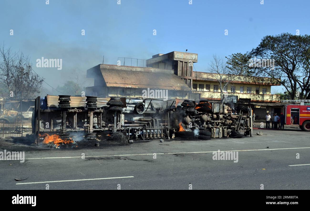 The overturned petrol tanker is seen at Charoti Naka in Dahanu district of Maharashtra, India, March 22, 2014. Seven people died and nine sustained burn injuries as a petrol tanker exploded on Mumbai-Ahmedabad national highway on Saturday afternoon, local media reported. (Xinhua/Stringer) INDIA-MAHARASHTRA-PETROL TANKER-FIRE PUBLICATIONxNOTxINxCHN   The overturned Petrol Tankers IS Lakes AT  Naka in  District of Maharashtra India March 22 2014 Seven Celebrities died and Nine sustained Burn  As a Petrol Tankers exploded ON Mumbai Ahmedabad National Highway ON Saturday Noon Local Media reported Stock Photo