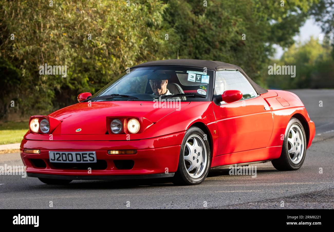 Whittlebury,Northants,UK -Aug 26th 2023: 1991 red Lotus Elan car with pop up headlights travelling on an English country road Stock Photo