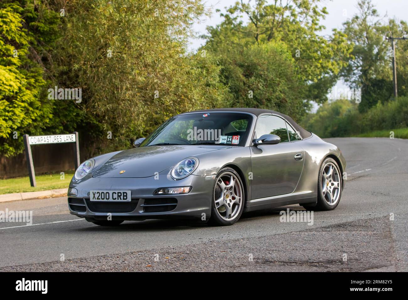 Whittlebury,Northants,UK -Aug 26th 2023: 2009 grey Porsche 911 Carrera car travelling on an English country road Stock Photo