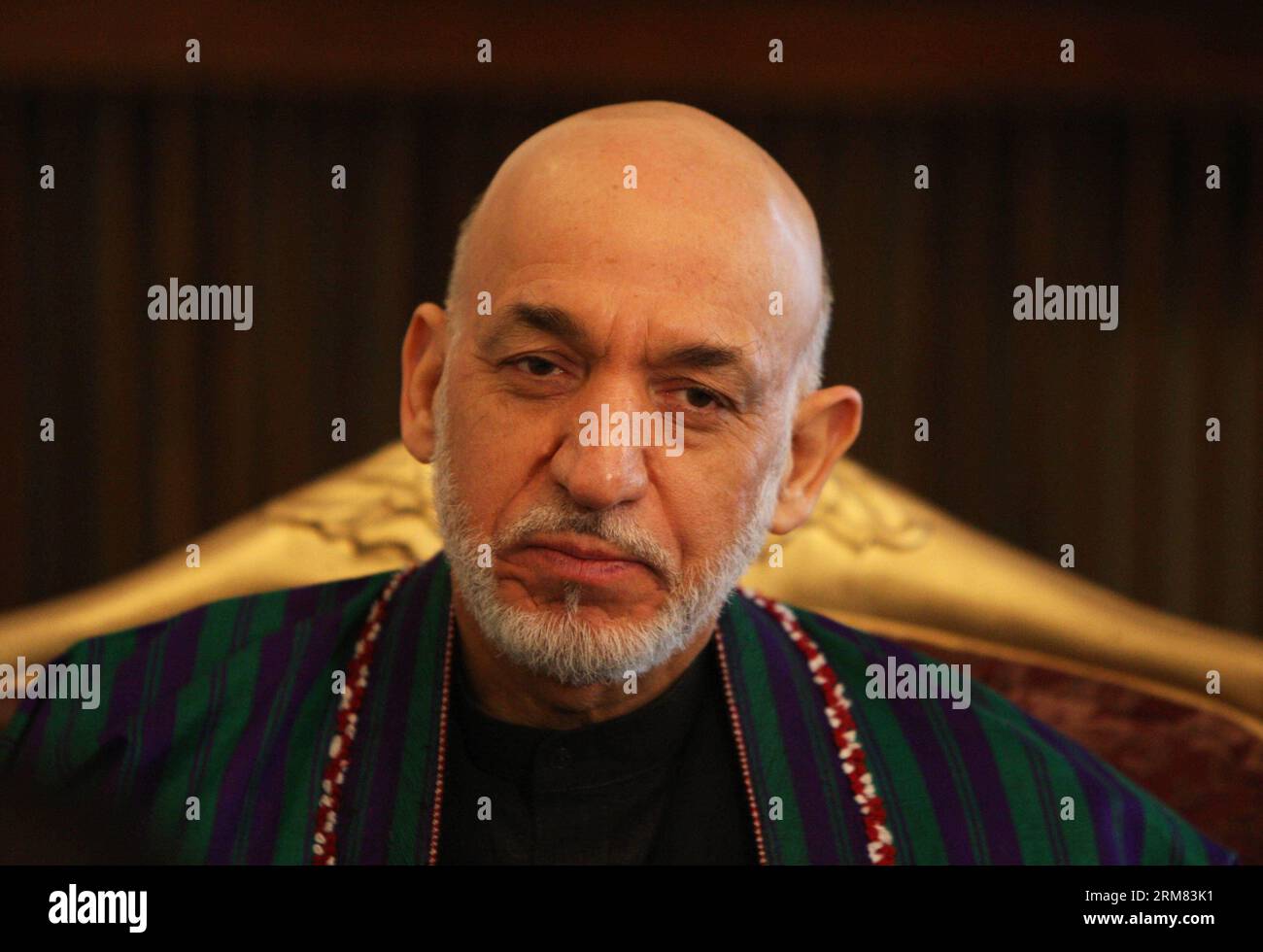 (140326) -- KABUL, March 26, 2014 (Xinhua) -- Afghan President Hamid Karzai listens during an interview with Xinhua News Agency at the presidential palace in Kabul, Afghanistan on March 26, 2014. Afghan President Hamid Karzai on Wednesday utterly rejected the rumors and reports suggesting he would sign the controversial Bilateral Security Agreement (BSA) with Washington before April 5 presidential elections to allow limited number of U.S. forces remain in Afghanistan after 2014 pullout of NATO-led troops from the militancy-plagued country. (Xinhua/Ahmad Massoud) (lmz) AFGHANISTAN-KABUL-PRESIDE Stock Photo
