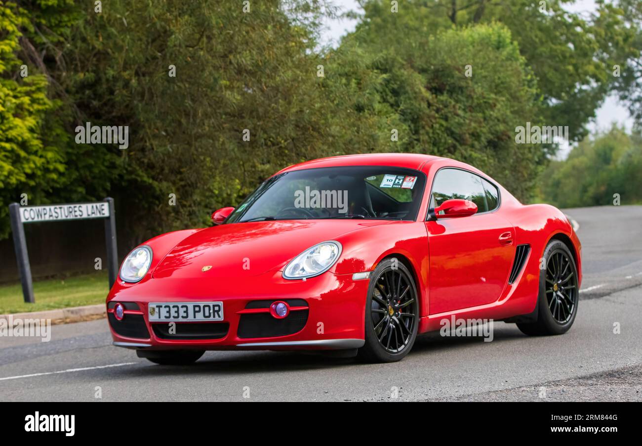 Whittlebury,Northants,UK -Aug 26th 2023: 2006 red Porsche Cayman S car travelling on an English country road Stock Photo