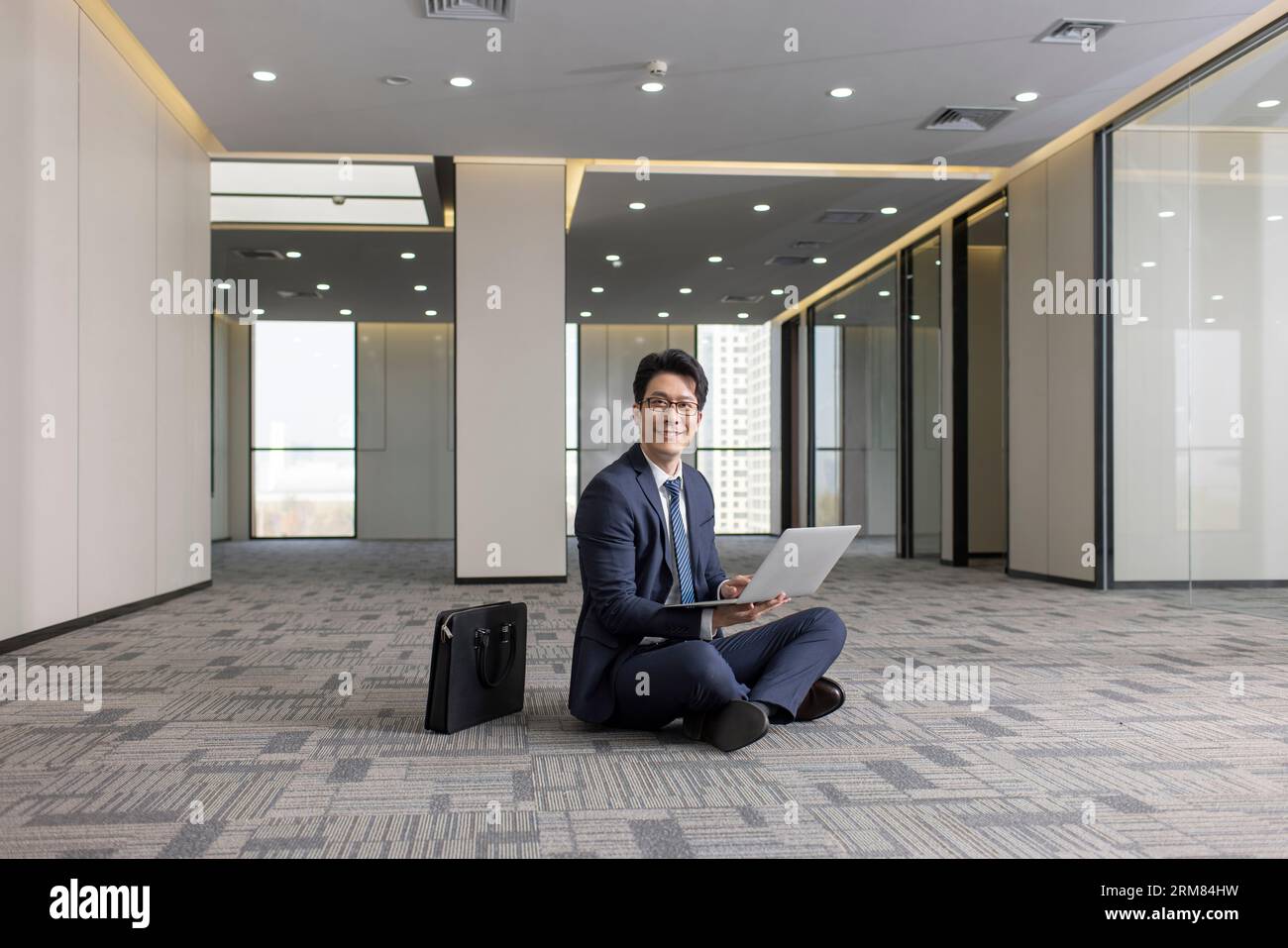 Businessman sitting cross legged on floor hi-res stock photography and ...
