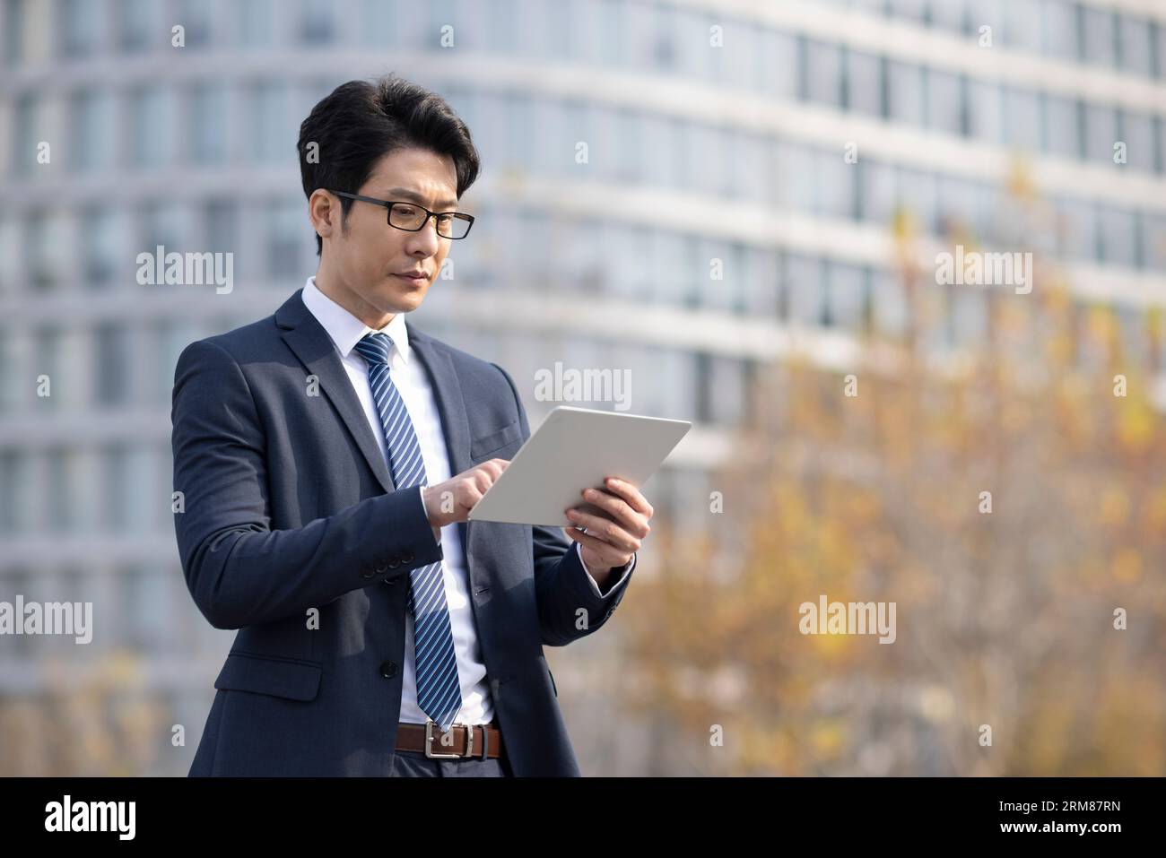 Confident businessman using digital tablet Stock Photo