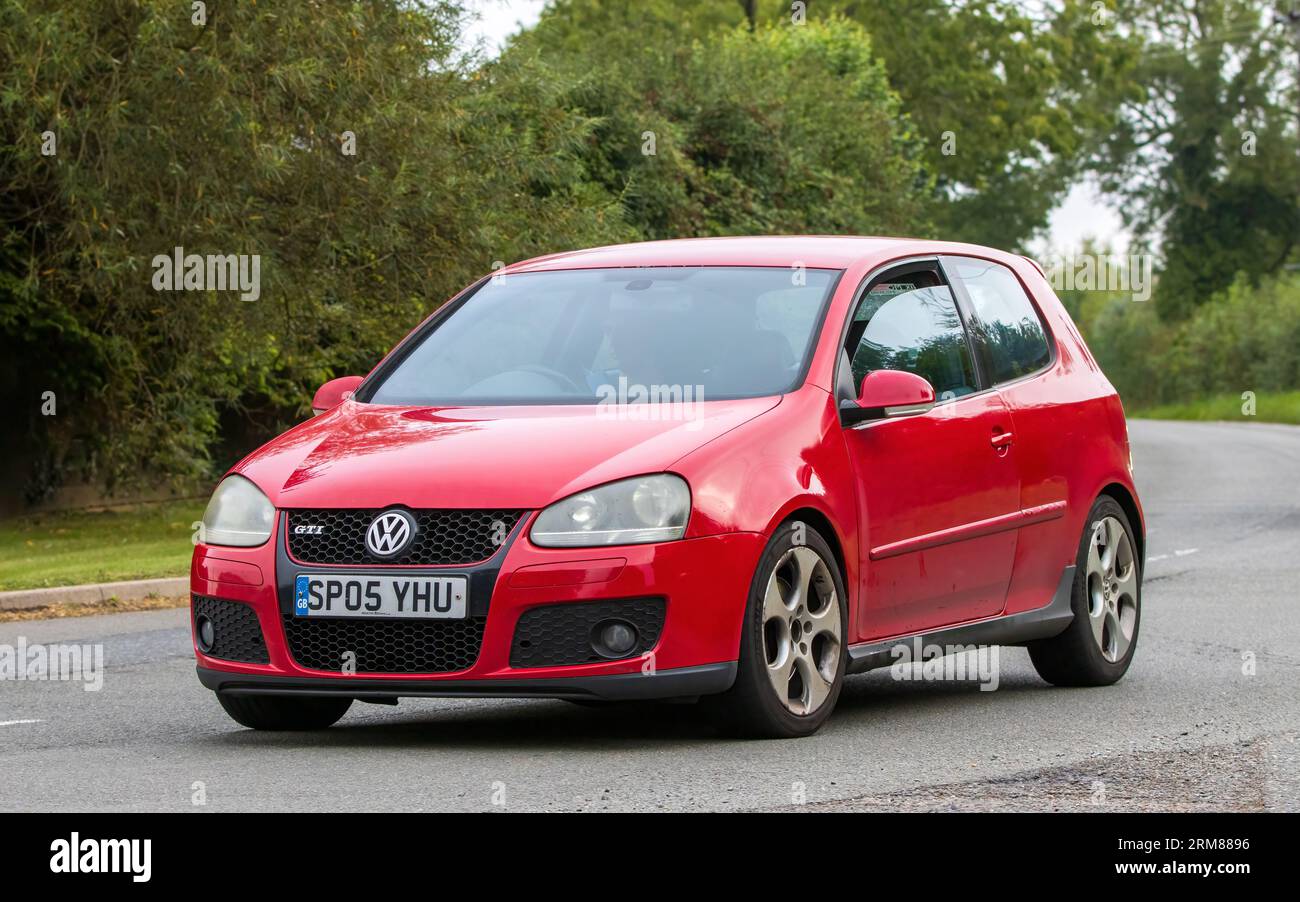 Whittlebury,Northants,UK -Aug 26th 2023: 2005 red Volkswagen Golf GTI car  travelling on an English country road Stock Photo - Alamy