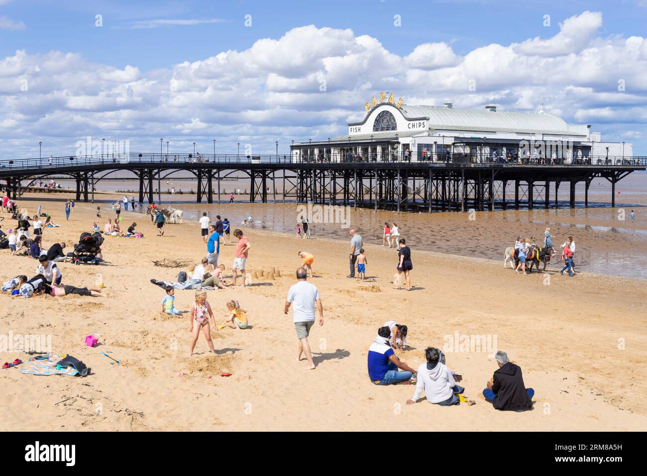 Cleethorpes beach with tourists and The Pier Cleethorpes with Papas fish and chips restaurant at Cleethorpes Lincolnshire England UK GB Europe Stock Photo