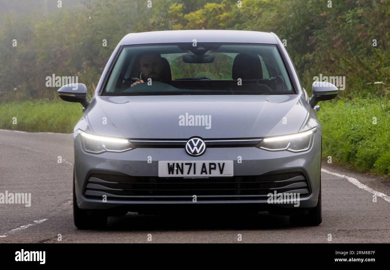 Whittlebury,Northants,UK -Aug 26th 2023:  Grey 2021 Volkswagen Golf car travelling on an English country road on a damp and misty morning. Stock Photo