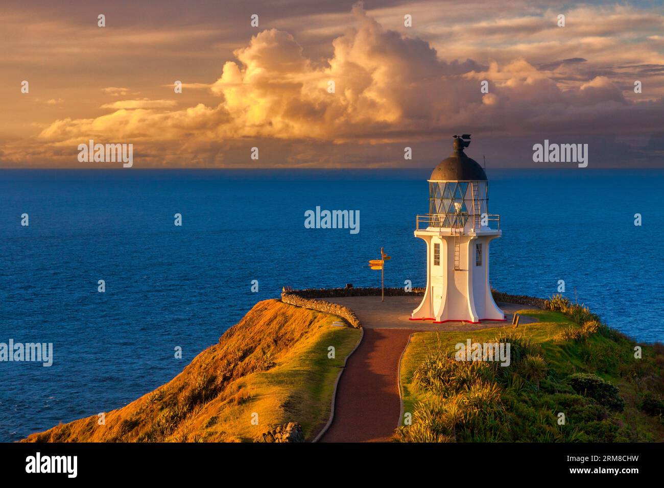 Cape Reinga lighthouse at sunset, with stunning evening light, Northland, New Zealand, is an icon of New Zealand and a must on the tourist trail. Stock Photo