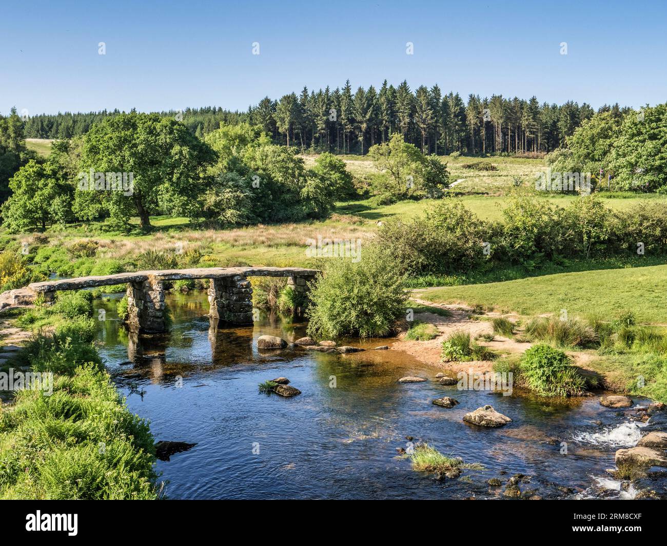 Old clapper bridge over the West Dart river at Postbridge, Dartmoor, Devon, UK. Stock Photo