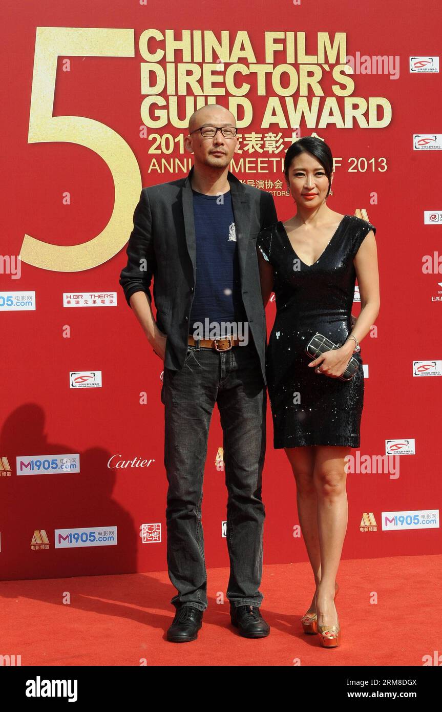 BEIJING,   Director Guan Hu and his wife Liang Jing, an actress, take part in the 2013 annual commendation conference of China Film Directors Guild in Beijing, capital of China, April 9, 2014. (Xinhua) (zwy) CHINA-BEIJING-COMMENDATION CONFERENCE-CHINA FILM DIRECTORS GUILD(CN) PUBLICATIONxNOTxINxCHN   Beijing Director Guan HU and His wife Liang Jing to actress Take Part in The 2013 Annual  Conference of China Film Directors Guild in Beijing Capital of China April 9 2014 XINHUA  China Beijing  Conference China Film Directors Guild CN PUBLICATIONxNOTxINxCHN Stock Photo