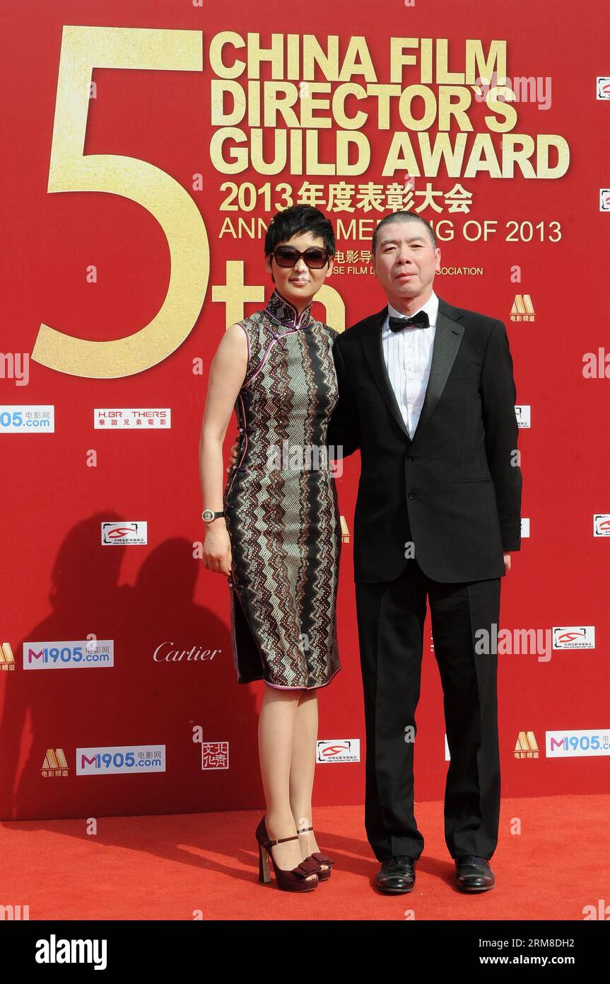 BEIJING,   Director Feng Xiaogang and his wife Xu Fan, an actress, take part in the 2013 annual commendation conference of China Film Directors Guild in Beijing, capital of China, April 9, 2014. (Xinhua) (zwy) CHINA-BEIJING-COMMENDATION CONFERENCE-CHINA FILM DIRECTORS GUILD(CN) PUBLICATIONxNOTxINxCHN   Beijing Director Feng Xiaogang and His wife Xu supporter to actress Take Part in The 2013 Annual  Conference of China Film Directors Guild in Beijing Capital of China April 9 2014 XINHUA  China Beijing  Conference China Film Directors Guild CN PUBLICATIONxNOTxINxCHN Stock Photo