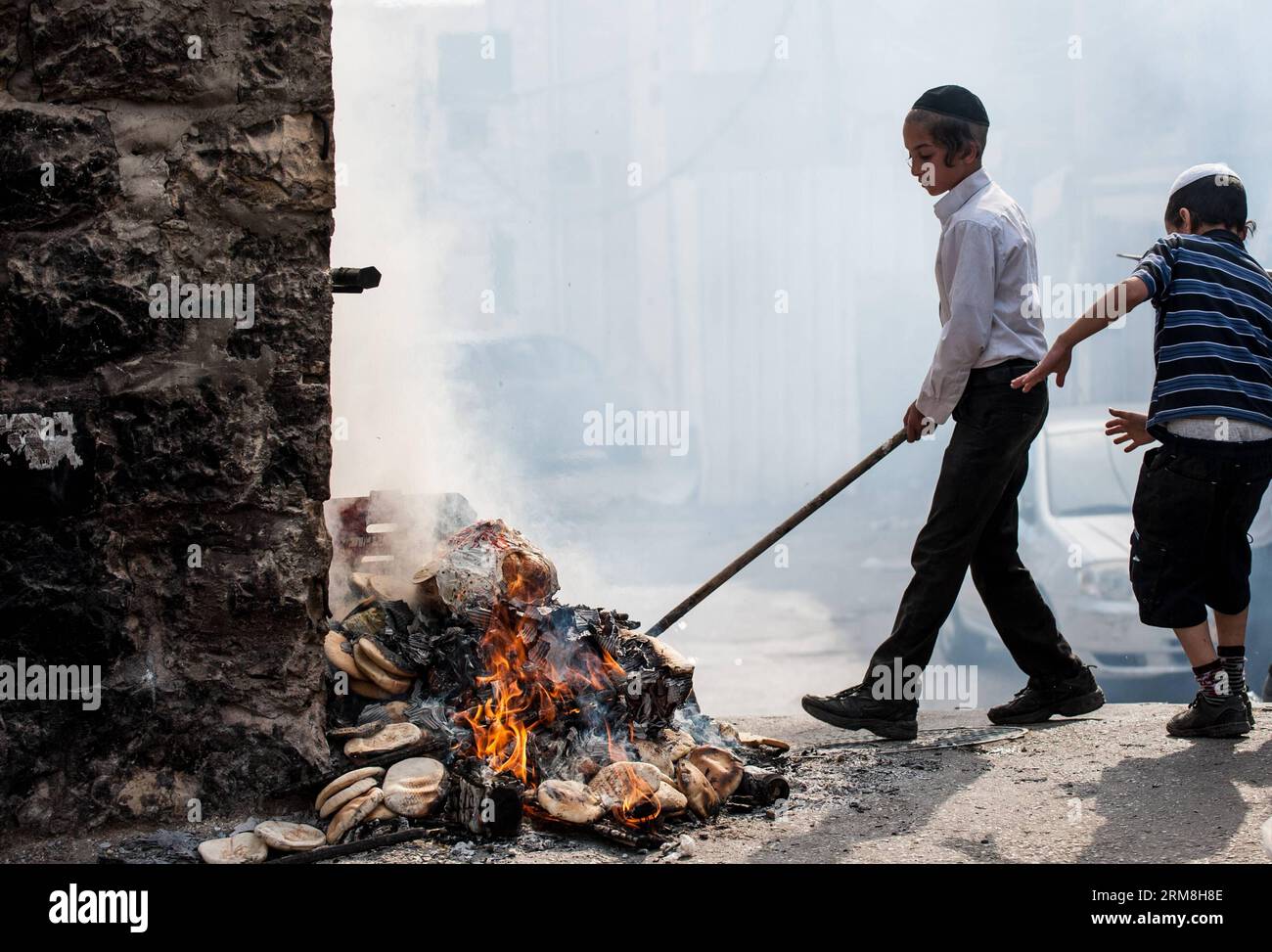 UltraOrthodox Jews burn leftover leavened food at Mea Shearim in Jerusalem, on April 14, 2014