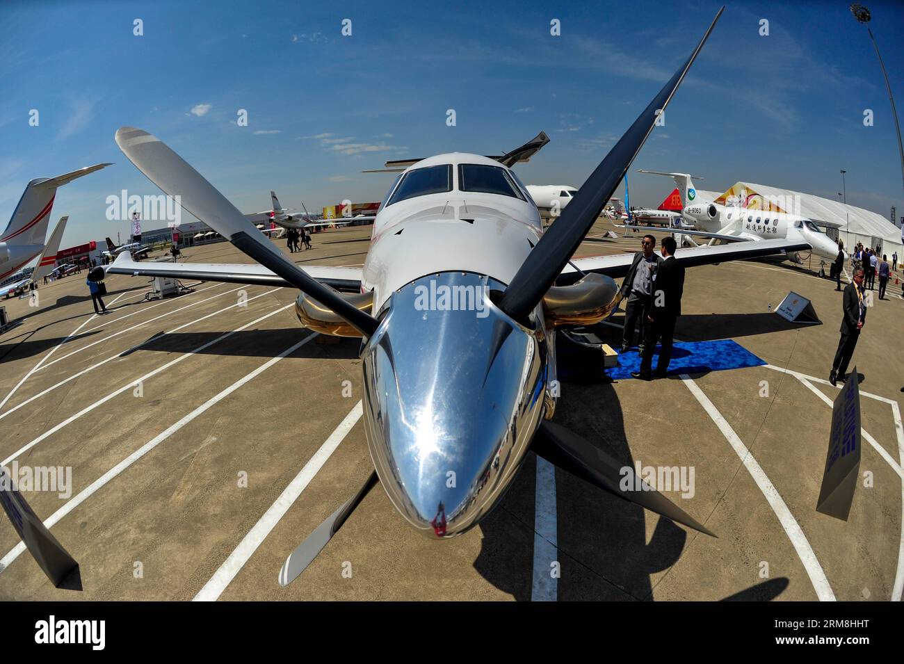 (140415) -- SHANGHAI, April 15, 2014 (Xinhua) -- A visitor looks at a Pilatus PC-12 business airplane at the 2014 Asian Business Aviation Conference & Exhibition (ABACE2014) in east China s Shanghai, April 15, 2014. ABACE2014, Asia s largest business aviation product and services event, kicked off Tuesday in Shanghai. Thirty-eight business aircrafts made by 20 manufacturers, including Boeing, Airbus and Bombardier, will be displayed during the three-day event. Their prices range from 3 million yuan (482,000 U.S. dollars) to 560 million yuan (89.99 million U.S. dollars). (Xinhua/Yang Guang) (lm Stock Photo