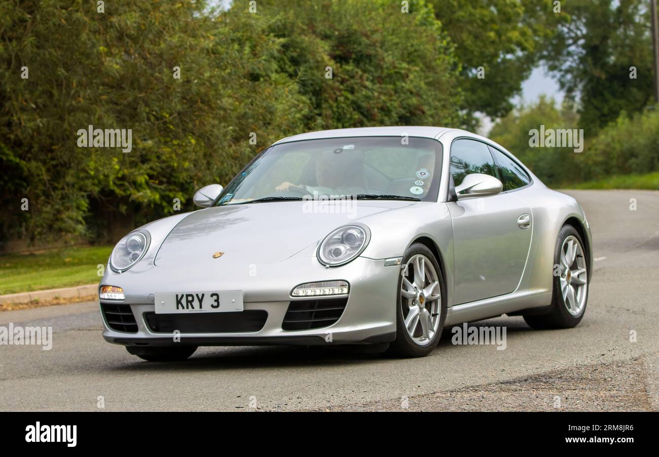 Whittlebury,Northants,UK -Aug 26th 2023: 2009 silver Porsche 911 Carrera car travelling on an English country road Stock Photo