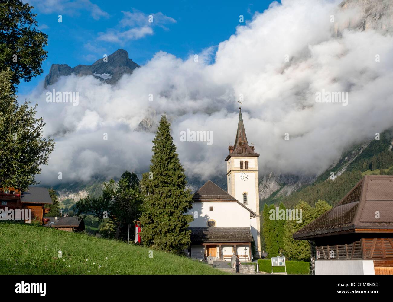 Grindelwald church with the Wetterhorn mountain behind, Bernese Alps, Grindelwald, Canton of Bern, Switzerland. Stock Photo