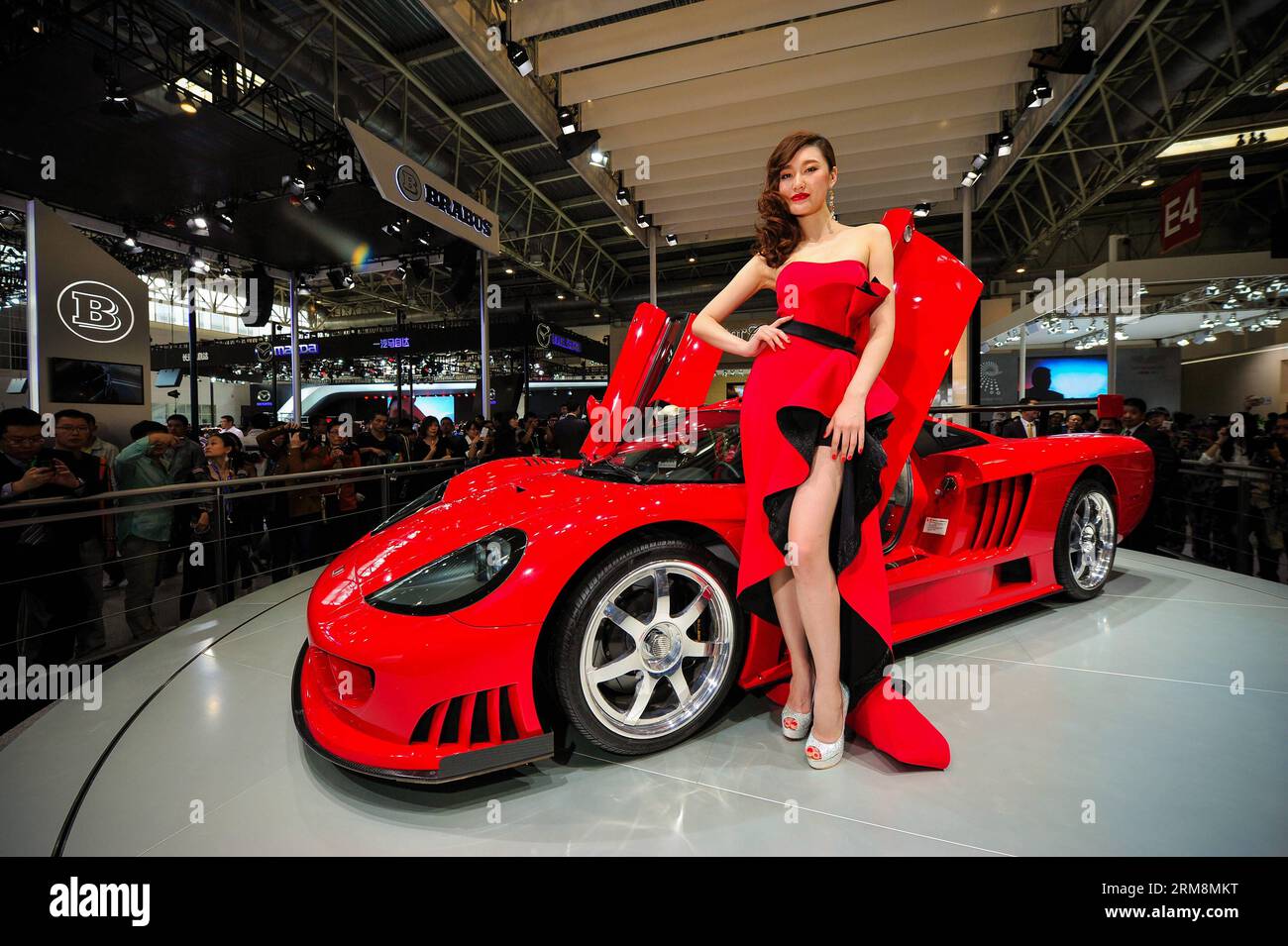 (140420) -- BEIJING, April 20, 2014 (Xinhua) -- A model presents a WM Saleen S7 sports car during the media preview of the 2014 Beijing International Automotive Exhibition in Beijing, China, April 20, 2014. Boasting 410 km/h top speed, the car is driven by a V8 7.0 liter engine producing 1060 horsepower and goes from 0 to 100 km/h in 2.4 seconds. The auto show will be held on April 21-29, attracting over 2,000 exhibitors from 14 countries and regions. (Xinhua/Yang Guang) (hdt) CHINA-BEIJING-AUTO-EXHIBITION (CN) PUBLICATIONxNOTxINxCHN   Beijing April 20 2014 XINHUA a Model Presents a World Cup Stock Photo