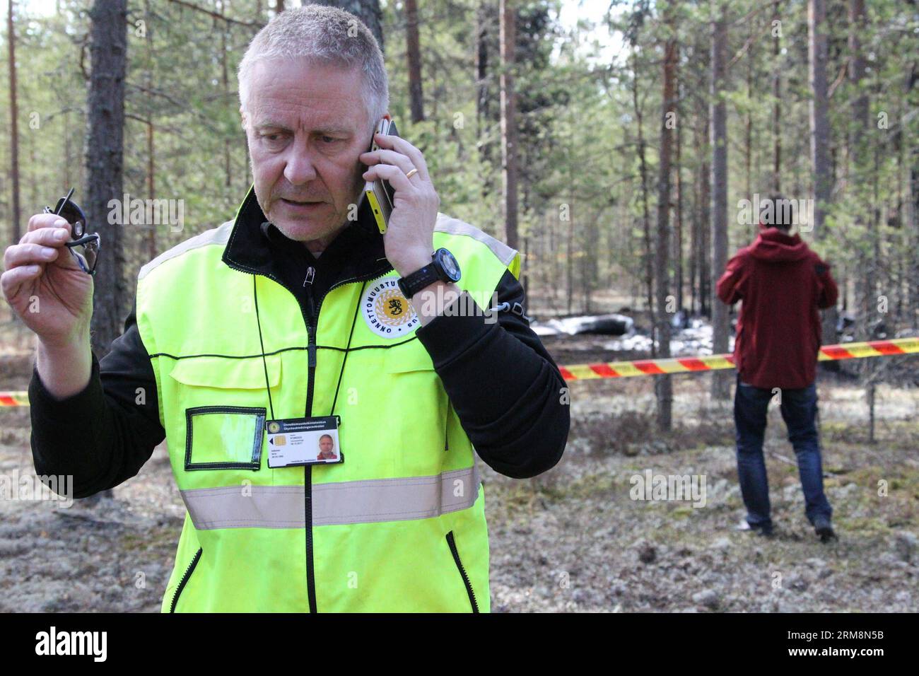 (140421) -- JAMIJARVI, April 21, 2014 (Xinhua) -- Head of the aviation investigation team Ismo Aaltonen works at the crash site near the Jamijarvi airport in southern Finland, April 21, 2014. A small passenger plane carrying 10 parachuters crashed on Sunday in the Satakunta region, Southwest Finland, causing eight dead. The pilot and two parachuters survived by ejecting from the aircraft before it crashed, and eight others were found dead around the wreckage. (Xinhua/Li Jizhi) FINLAND-JAMIJARVI-PLANE CRASH PUBLICATIONxNOTxINxCHN   April 21 2014 XINHUA Head of The Aviation Investigation Team  A Stock Photo