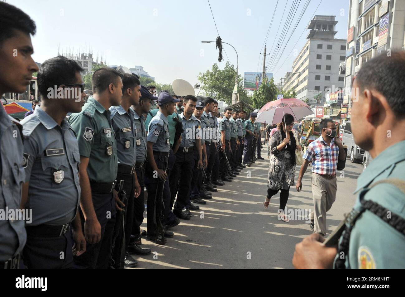(140422) -- DHAKA, April 22, 2014 (Xinhua) -- Policemen stand guard on a street during a long march in Dhaka, Bangladesh, April 22, 2014. Demanding equitable share of common Teesta river water from India, Bangladesh Nationalist Party (BNP) started its two-day road march towards a barrage on Teesta river in an area bordering Lalmonirhat district, some 343 km northwest of Dhaka. (Xinhua/Shariful Islam) BANGLADESH-DHAKA-PROTEST PUBLICATIONxNOTxINxCHN   Dhaka April 22 2014 XINHUA Policemen stand Guard ON a Street during a Long March in Dhaka Bangladesh April 22 2014 demanding Equitable Share of Co Stock Photo
