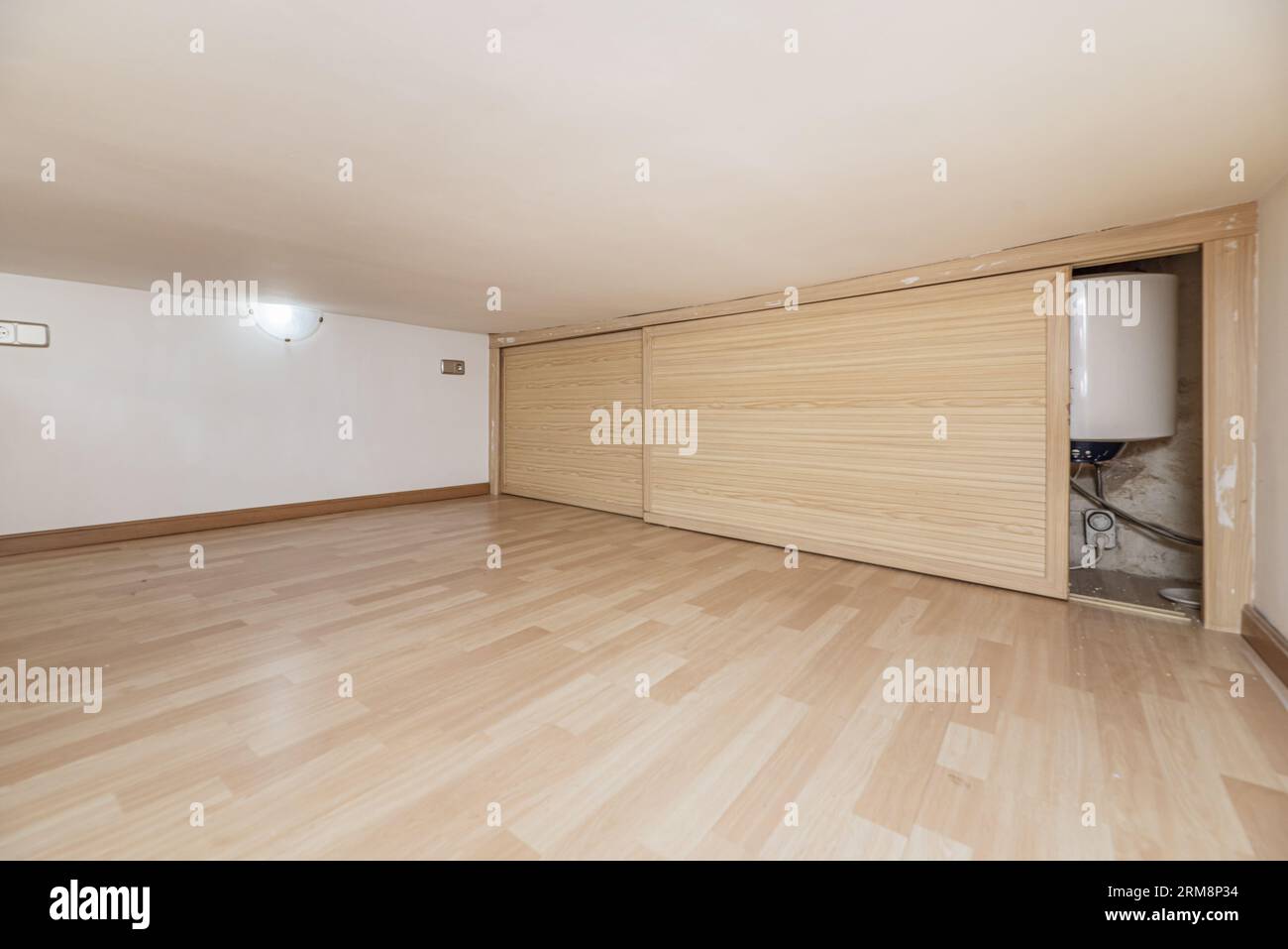 wooden sliding doors that cover a hole in a low-rise storage room Stock Photo