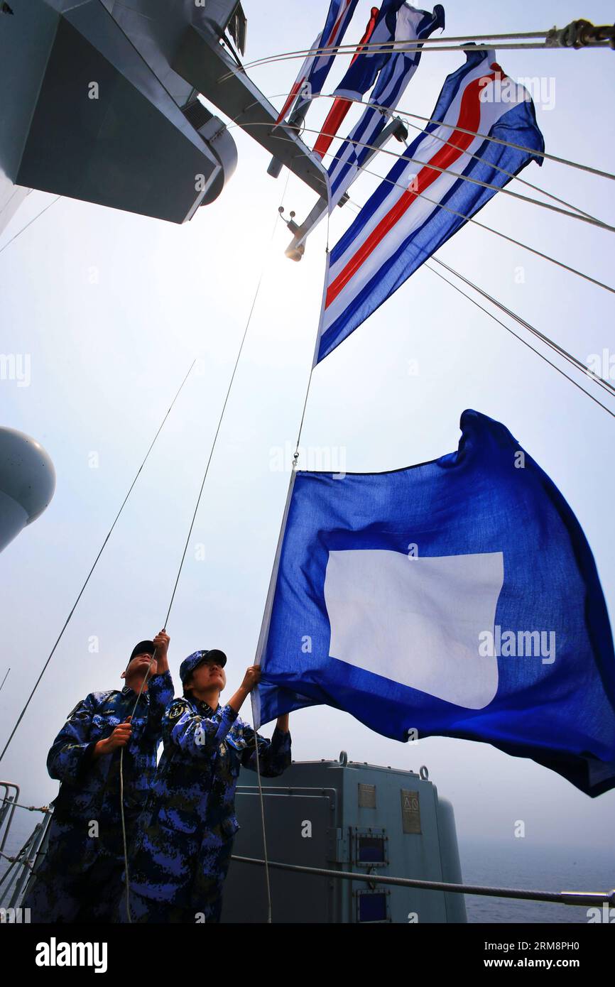 (140423) -- QINGDAO, April 23, 2014 (Xinhua) -- Soldiers hang up a signal flag on the Chinese naval ship during the multi-country maritime exercises off the coast of Qingdao, east China s Shandong Province, April 23, 2014. Nineteen ships, seven helicopters and marine corps from eight countries including China, Bangladesh, Pakistan, Singapore, Indonesia, India, Malaysia and Brunei were organized into three task forces to conduct the exercises dubbed Maritime Cooperation - 2014 . (Xinhua/Zha Chunming) (mp) CHINA-QINGDAO-MULTI-COUNTRY MARITIME EXERCISES (CN) PUBLICATIONxNOTxINxCHN   Qingdao April Stock Photo