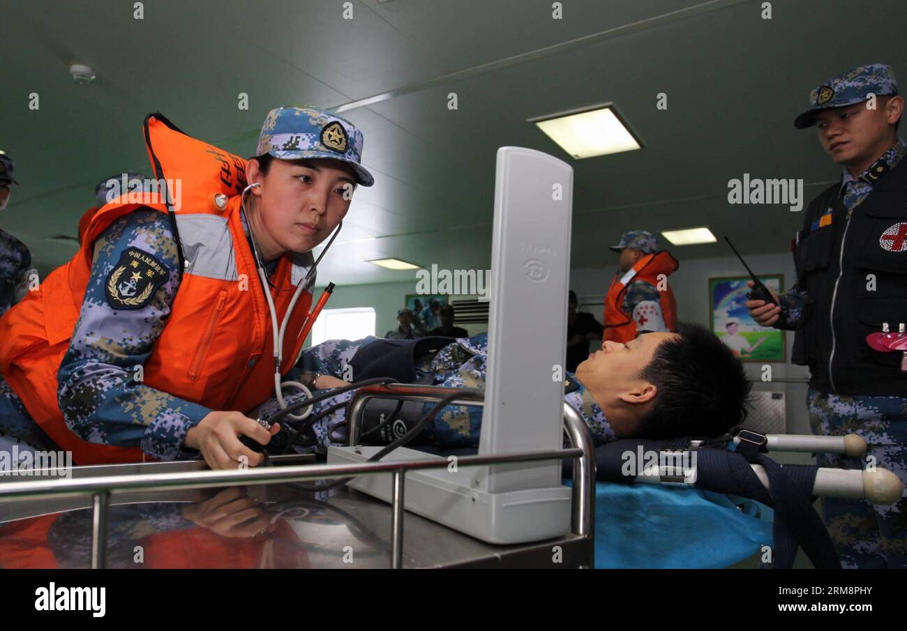 (140423) -- QINGDAO, April 23, 2014 (Xinhua) -- Medical staff members provide treatment for the wounded during the multi-country maritime exercises off the coast of Qingdao, east China s Shandong Province, April 23, 2014. Nineteen ships, seven helicopters and marine corps from eight countries including China, Bangladesh, Pakistan, Singapore, Indonesia, India, Malaysia and Brunei were organized into three task forces to conduct the exercises dubbed Maritime Cooperation - 2014 . (Xinhua/Huang Yuping) (mp) CHINA-QINGDAO-MULTI-COUNTRY MARITIME EXERCISES (CN ) PUBLICATIONxNOTxINxCHN   Qingdao April Stock Photo