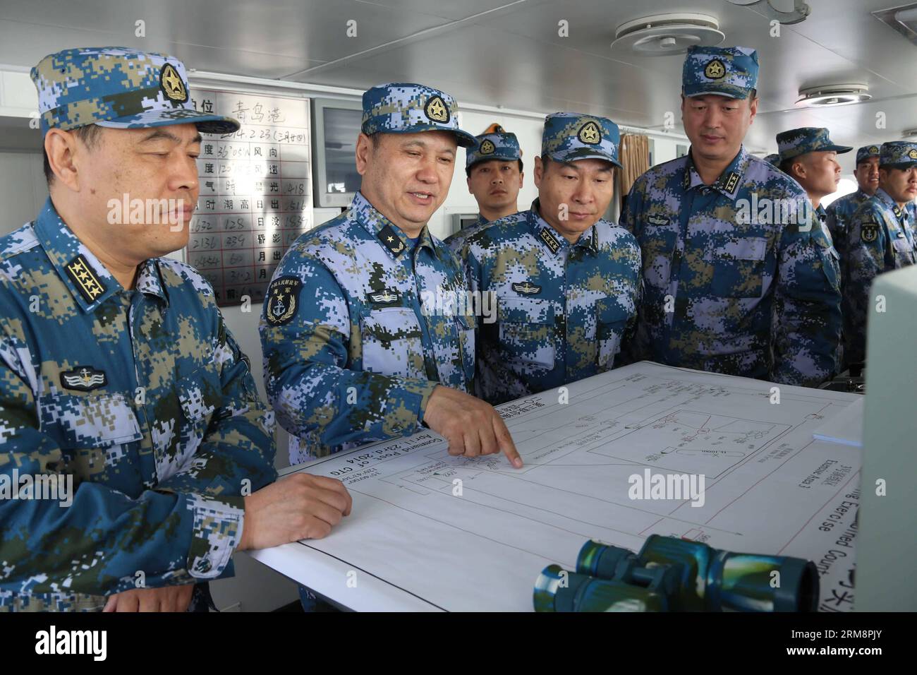 (140423) -- QINGDAO, April 23, 2014 (Xinhua) -- Commanders discuss the battle plan on the Chinese destroyer Harbin during the multi-country maritime exercises off the coast of Qingdao, east China s Shandong Province, April 23, 2014. Nineteen ships, seven helicopters and marine corps from eight countries including China, Bangladesh, Pakistan, Singapore, Indonesia, India, Malaysia and Brunei were organized into three task forces to conduct the exercises dubbed Maritime Cooperation - 2014 . (Xinhua/Wang Jianmin) (mp) CHINA-QINGDAO-MULTI-COUNTRY MARITIME EXERCISES (CN) PUBLICATIONxNOTxINxCHN   Qin Stock Photo