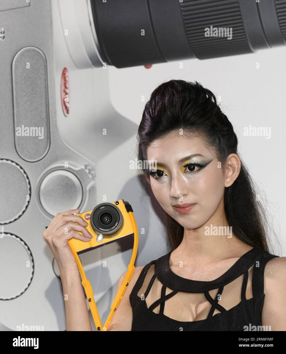 (140430) -- TAIPEI, April 30, 2014 (Xinhua) -- A model demonstrates a brand-new Leica T camera at a release ceremony in Taipei, southeast China s Taiwan, April 30, 2014. German camera manufacturer Leica released its latest T system cameras Wednesday at the Songshan Cultural Park in Taipei. The Leica T system features a 16.3-megapixel APS-C CMOS sensor in a minimalist design and supports wireless transmission of photographic works to users mobile devices and social networks. (Xinhua/Huang Xiaoyong) (lmm) CHINA-TAIPEI-CAMERA-LEICA T SYSTEM-RELEASE (CN) PUBLICATIONxNOTxINxCHN   Taipei April 30 20 Stock Photo