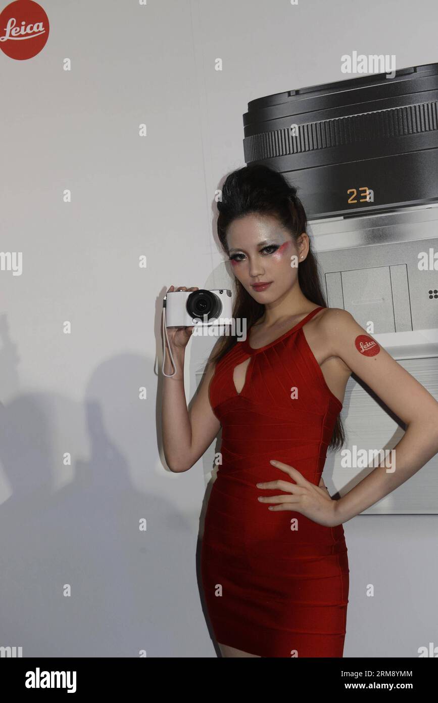 (140430) -- TAIPEI, April 30, 2014 (Xinhua) -- A model demonstrates a brand-new Leica T camera at a release ceremony in Taipei, southeast China s Taiwan, April 30, 2014. German camera manufacturer Leica released its latest T system cameras Wednesday at the Songshan Cultural Park in Taipei. The Leica T system features a 16.3-megapixel APS-C CMOS sensor in a minimalist design and supports wireless transmission of photographic works to users mobile devices and social networks. (Xinhua/Huang Xiaoyong) (lmm) CHINA-TAIPEI-CAMERA-LEICA T SYSTEM-RELEASE (CN) PUBLICATIONxNOTxINxCHN   Taipei April 30 20 Stock Photo