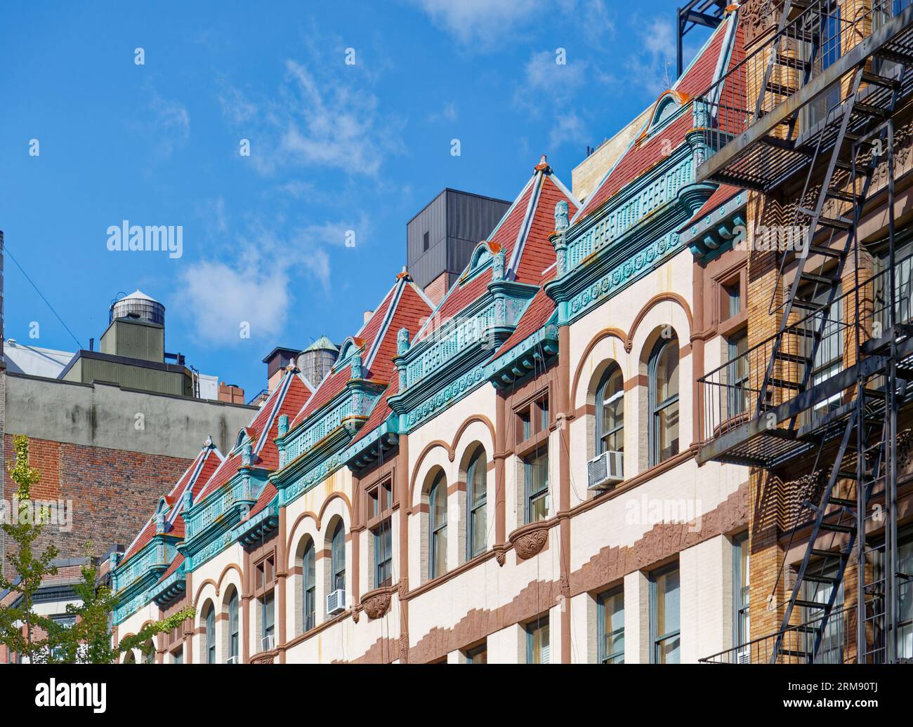 Upper West Side: A fanciful tile roofline fronts the flat roofs of 337-329 West 85th Street, landmark Queen Anne-styled row houses built in 1891. Stock Photo