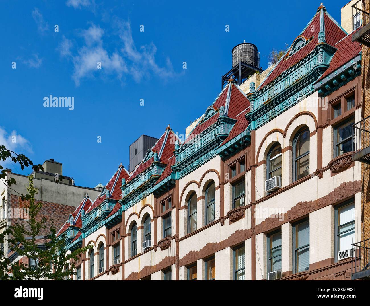 Upper West Side: A fanciful tile roofline fronts the flat roofs of 337-329 West 85th Street, landmark Queen Anne-styled row houses built in 1891. Stock Photo