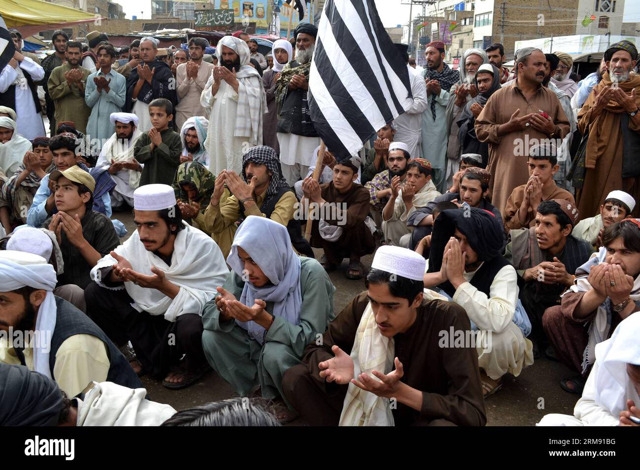 Pakistani protester pray during a protest on the third anniversary of the death of slain Al-Qaeda leader Osama bin Laden, in southwest Pakistan s Quetta on May 2, 2014. Osama bin Laden was killed by U.S. military force on May 2, 2011, in a fortress-like compound on the outskirts of Pakistani city of Abbottabad. (Xinhua/Asad) (WORLD SECTION) PAKISTAN-QUETTA-BIN LADEN-PROTEST PUBLICATIONxNOTxINxCHN   Pakistani  Pray during a Protest ON The Third Anniversary of The Death of Slain Al Qaeda Leader Osama am shop in Southwest Pakistan S Quetta ON May 2 2014 Osama am shop what KILLED by U S Military F Stock Photo