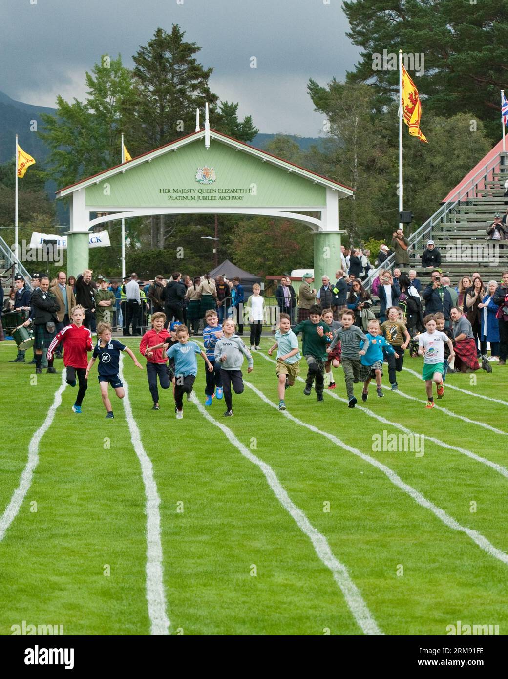 Young boys running race at Braemar Gathering, Highland Games, Aberdeenshire. Stock Photo