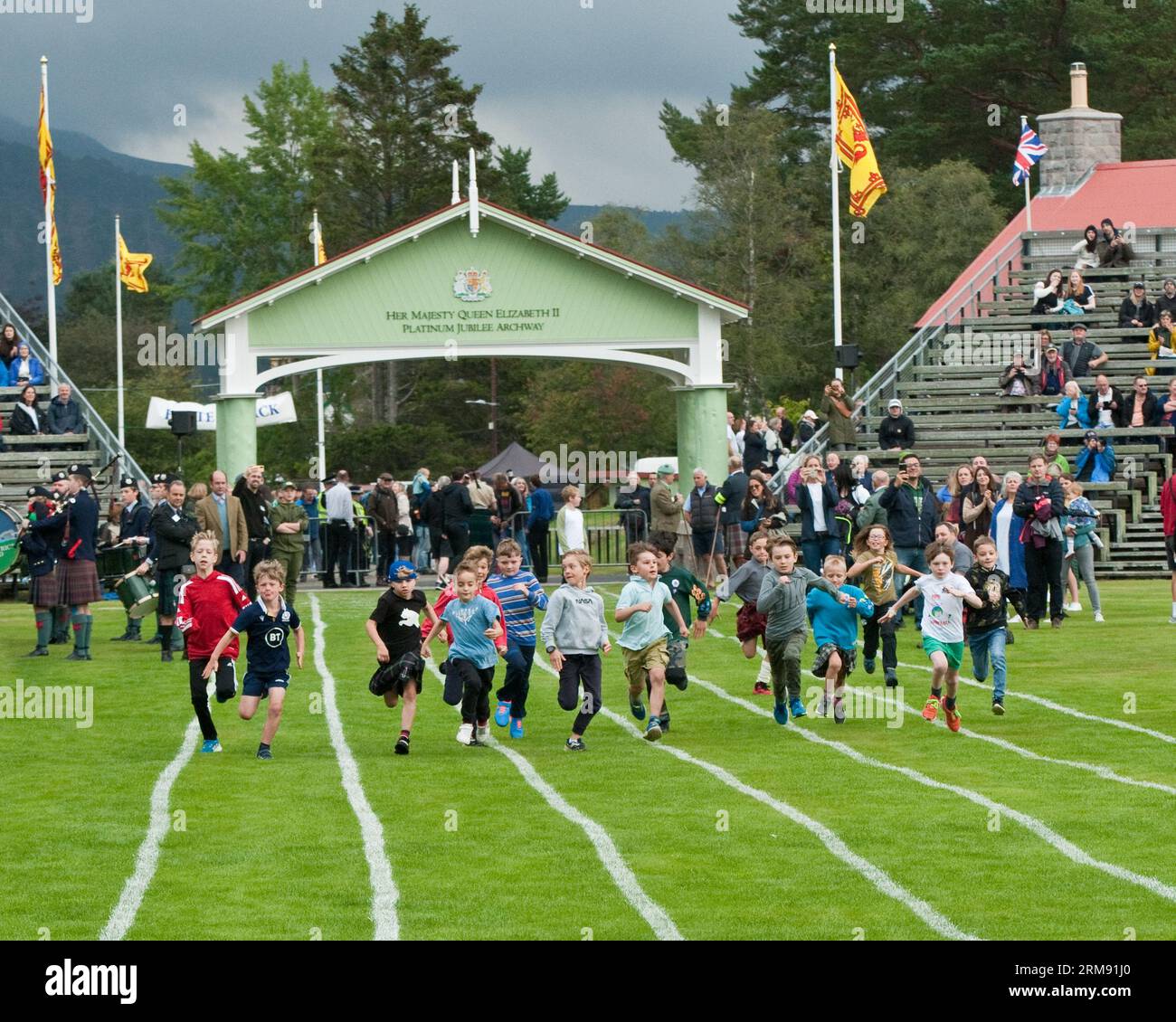 Young boys running race at Braemar Gathering, Highland Games, Aberdeenshire. Stock Photo