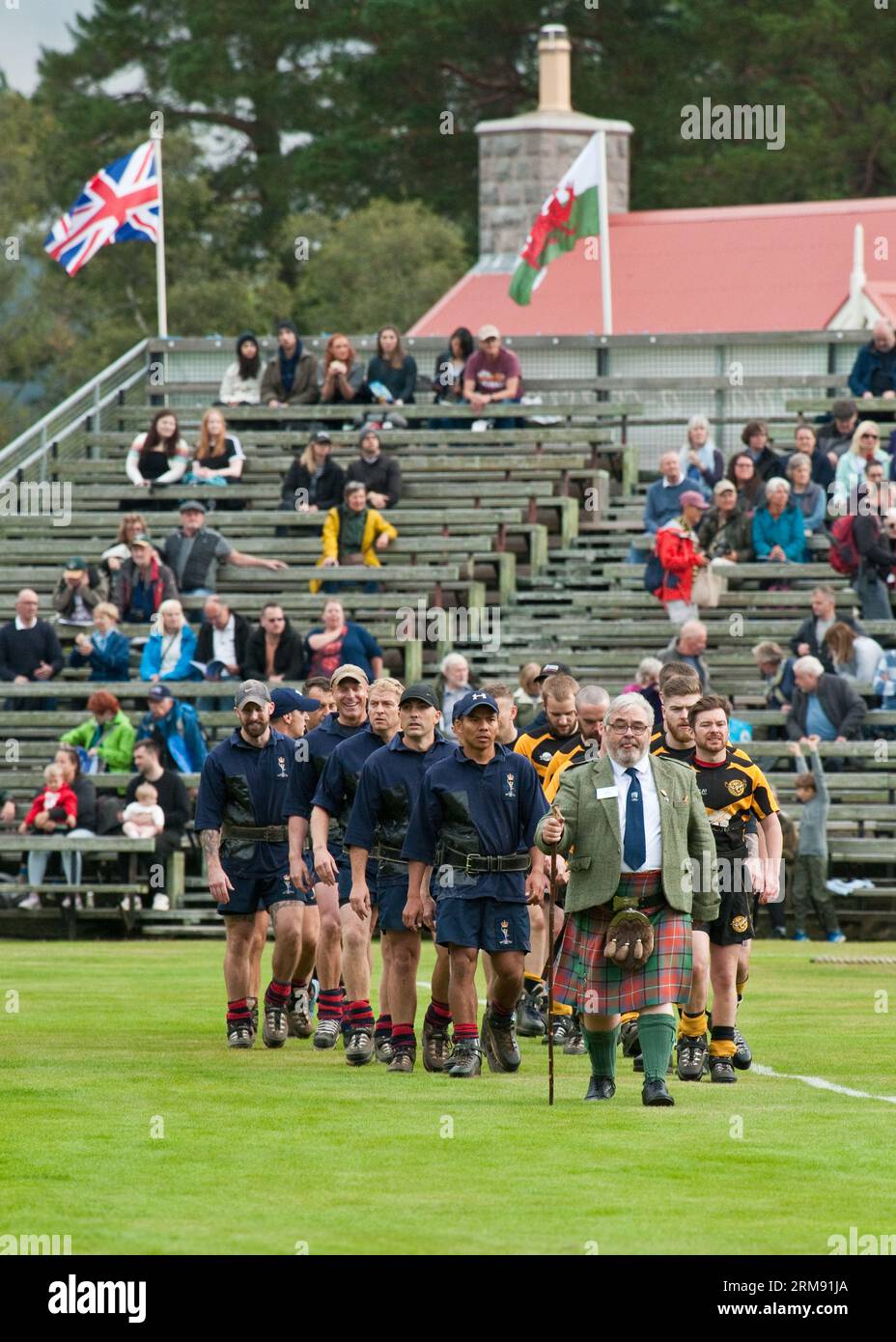 Tug of War teams entering the field, Braemar Highland Games, Scotland Stock Photo