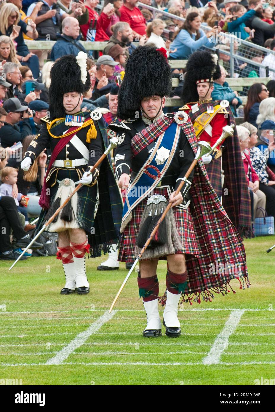 Scottish Massed Pipe Bands marching and playing at the 'The Braemar Gathering', Highland Games, Scotland. Stock Photo