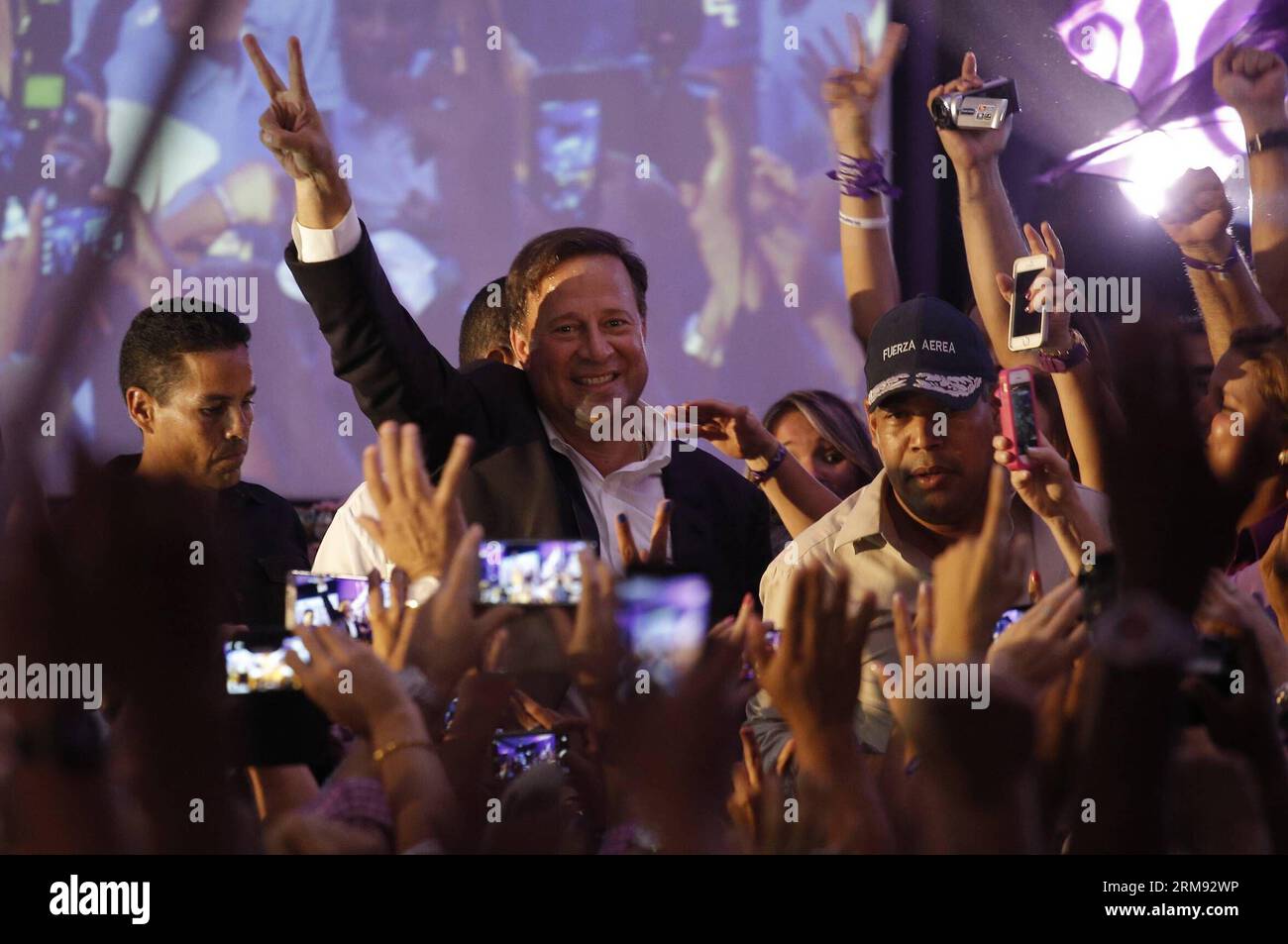 PANAMA CITY, May 4, 2014 (Xinhua) -- Presidential candidate Juan Carlos Varela (C) from the Panamenista Party greets his supporters after the preliminary results of the general elections, in Panama City, capital of Panama, on May 4, 2014. President of the Supreme Electoral Court Erasmo Pinilla said on Sunday night that Juan Carlos Varela is the virtual winner of Panama s presidency.(Xinhua/Mauricio Valenzuela) PANAMA-PANAMA CITY-POLITICS-ELECTIONS PUBLICATIONxNOTxINxCHN   Panama City May 4 2014 XINHUA Presidential Candidate Juan Carlos Varela C from The  Party greets His Supporters After The p Stock Photo
