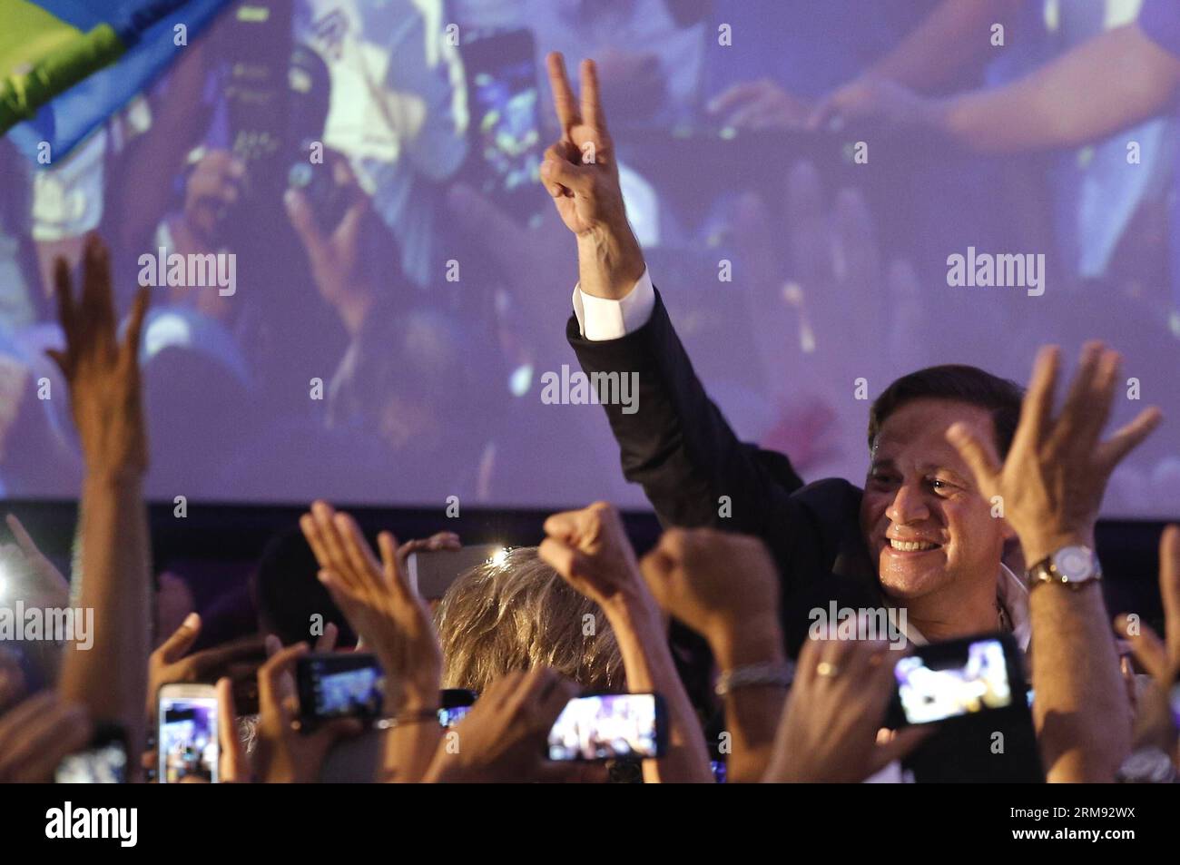 PANAMA CITY, May 4, 2014 (Xinhua) -- Presidential candidate Juan Carlos Varela (R) from the Panamenista Party greets his supporters after the preliminary results of the general elections, in Panama City, capital of Panama, on May 4, 2014. President of the Supreme Electoral Court Erasmo Pinilla said on Sunday night that Juan Carlos Varela is the virtual winner of Panama s presidency.(Xinhua/Mauricio Valenzuela) PANAMA-PANAMA CITY-POLITICS-ELECTIONS PUBLICATIONxNOTxINxCHN   Panama City May 4 2014 XINHUA Presidential Candidate Juan Carlos Varela r from The  Party greets His Supporters After The p Stock Photo