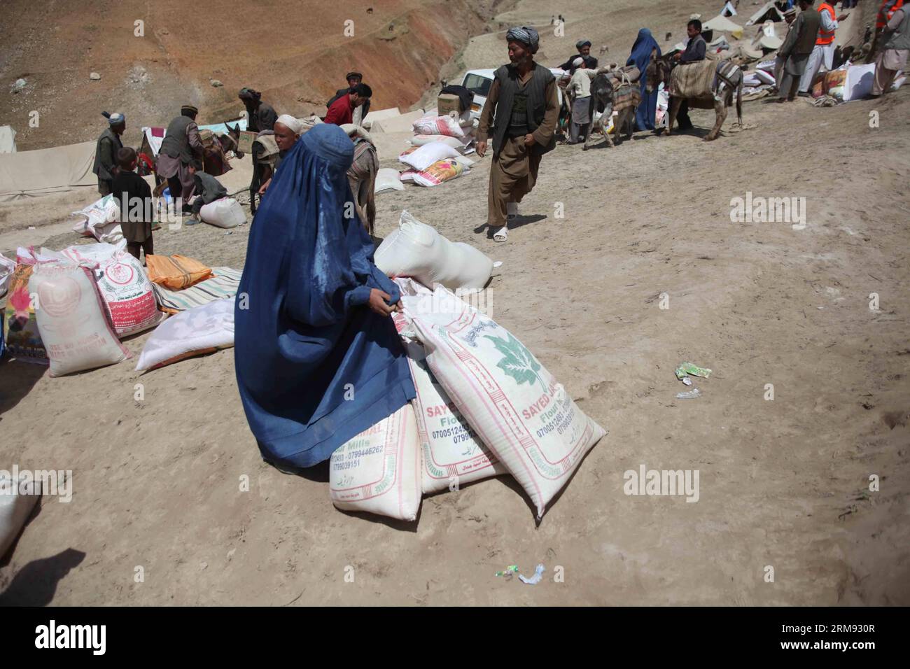 Afghan women receive relief food after the landslide in Badakhshan province in northern Afghanistan on May 5, 2014. More than 2,500 people are feared to have lost their lives in the landslide happening Friday in a remote village in northern Afghanistan. Days of heavy rain in the mountainous Badakhshan province caused the landslide. (Xinhua/Ahmad Massoud) (bxq) AFGHANISTAN-BADAKHSHAN-LANDSLIDE-AFTERMATH PUBLICATIONxNOTxINxCHN   Afghan Women receive Relief Food After The landslide in Badakhshan Province in Northern Afghanistan ON May 5 2014 More than 2 500 Celebrities are feared to have Lost the Stock Photo
