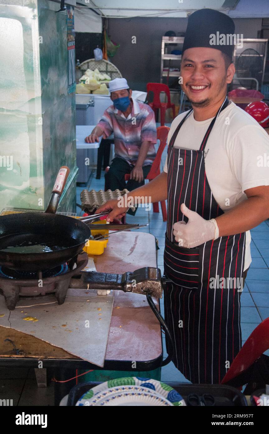 Short-order cook working at a cafe in Sibu, Sarawak, Malaysia Stock Photo