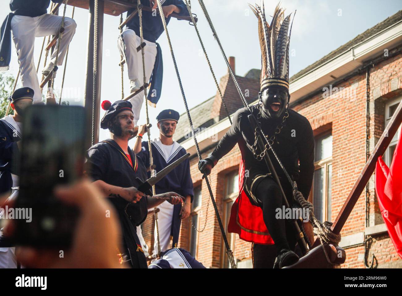 The 'Sauvage' pictured during the Ducasse festivities with the marriage of the two giants, Monsieur et Madame Goliath', in Ath, Sunday 27 August 2023. In recent years, the presence of the 'Sauvage' as an extra in the procession has caused controversy, as he has been accused of racism due to his 'blackface'-style make-up and several of his attributes. The Sauvage, as we know him, will be present and will transform himself during the procession. The organisers are announcing a surprise at the end of the parade. This character will no longer have a human appearance. BELGA PHOTO JUSTIN NAMUR Credi Stock Photo