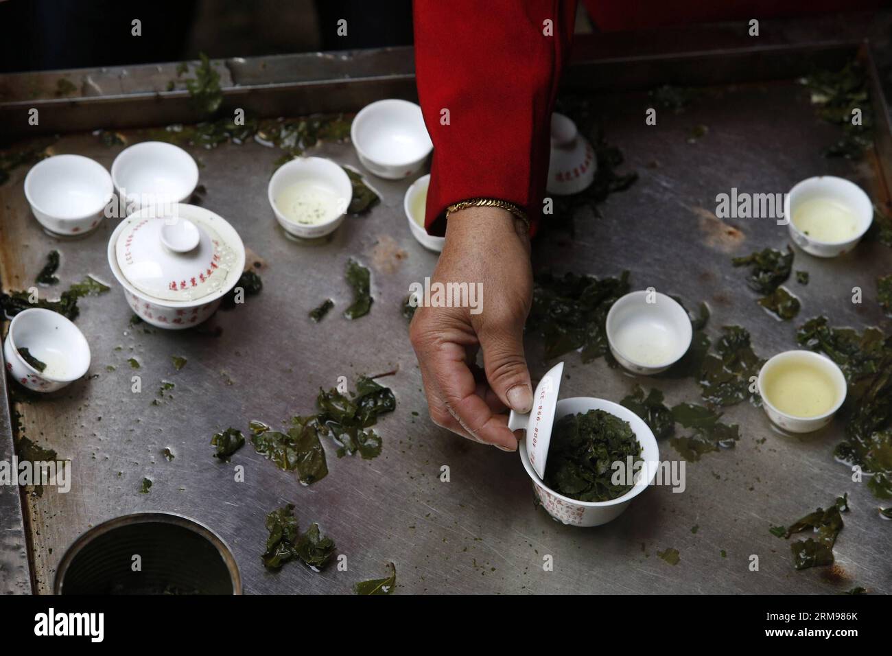 https://c8.alamy.com/comp/2RM986K/anxi-may-10-2014-xinhua-a-customer-tastes-sample-tieguanyin-the-best-oolong-tea-variety-produced-in-anxi-county-at-anxi-tea-wholesale-market-in-southeast-china-s-fujian-province-may-10-2014-anxi-has-over-40000-hectares-of-tea-gardens-with-an-annual-production-of-around-68000-tons-of-tea-about-800000-anxi-people-are-involved-in-the-tea-industry-xinhuashen-bohan-wf-china-fujian-anxi-tea-trade-cn-publicationxnotxinxchn-anxi-may-10-2014-xinhua-a-customer-tastes-sample-the-best-oolong-tea-variety-produced-in-anxi-county-at-anxi-tea-wholesale-market-in-south-east-china-s-2RM986K.jpg