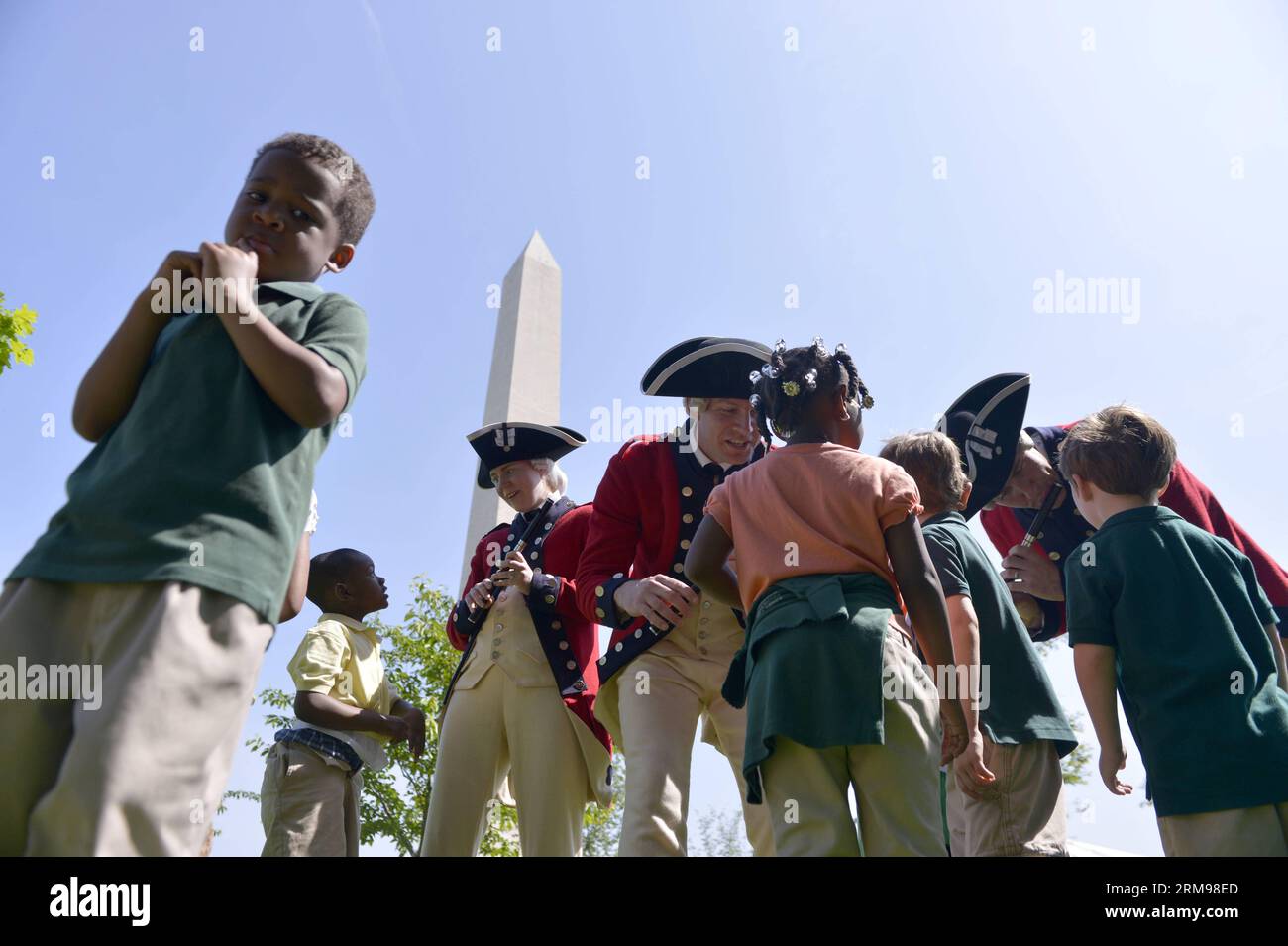 (140512) -- WASHINGTON D.C., May 12, 2014 (Xinhua) -- Children play with soldiers of a military band attending the reopening ceremony of the Washington Monument, in Washington D.C., the United States, on May 12, 2014. The iconic Washington Monument in this American national capital on Monday reopened on completion of 32-month repairs with a cost of 15 million U.S. dollars.(Xinhua/Yin Bogu) U.S.-WASHINGTON MONUMENT-REOPENING PUBLICATIONxNOTxINxCHN   Washington D C May 12 2014 XINHUA Children Play With Soldiers of a Military Tie attending The Reopening Ceremony of The Washington Monument in Wash Stock Photo