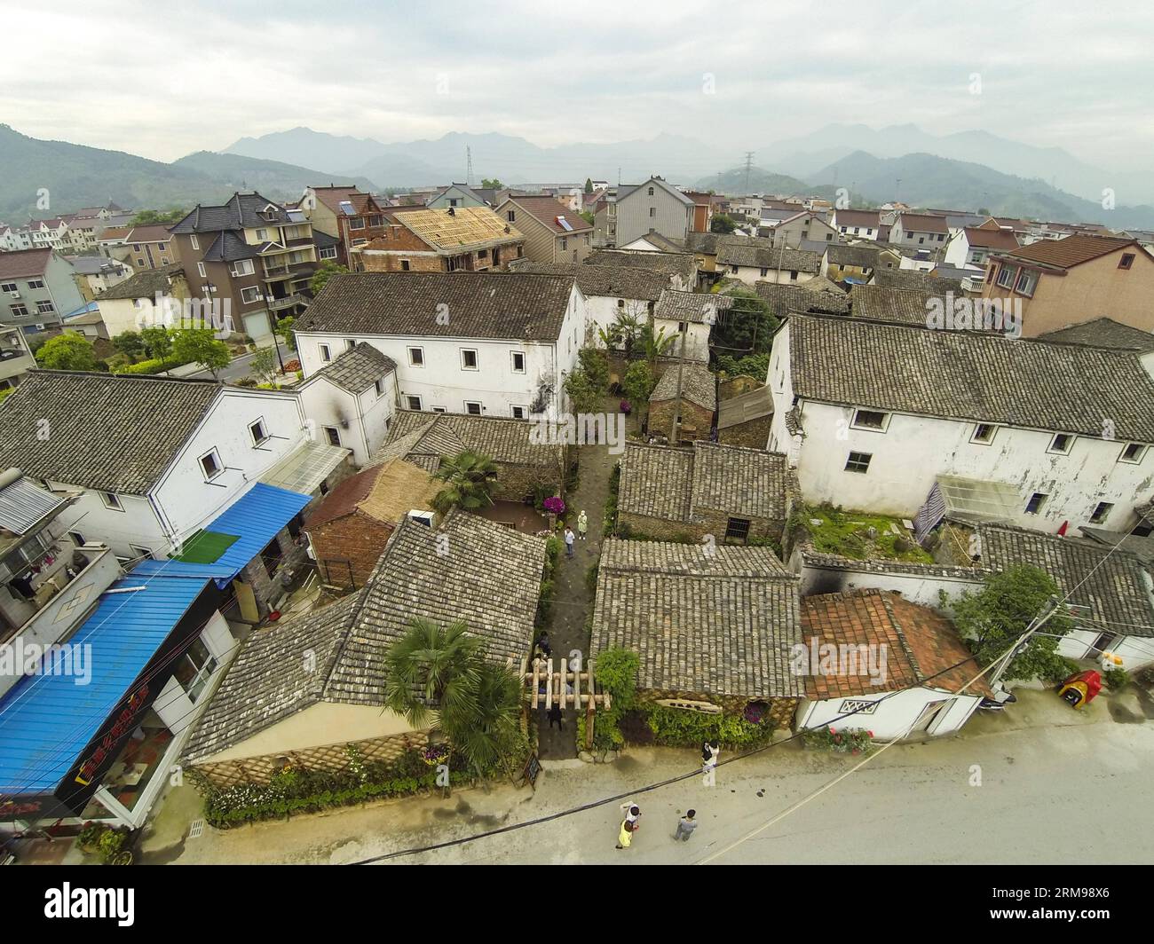 (140513) -- TONGLU, May 13, 2014 (Xinhua) -- Photo taken on May 13, 2014 shows the five houses of the swinery tea bar in Dipu Village of Jiangnan Town in Tonglu County, east China s Zhejiang Province. Dipu Village, a national historical and cultural village with nearly a thousand years history, has committed to environment reform, village protection and tourism development for the past few years. The swinery tea bar sets a successful example of the transform. The bar used to be five messy stone houses for pigs keeping. After renovation, it functions as a modern tea bar with traditional appeara Stock Photo