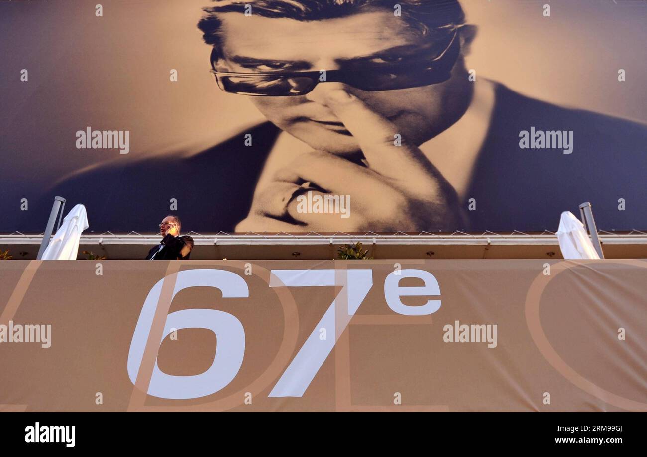 (140514) -- CANNES, May 14, 2014 (Xinhua) -- A man walks past a giant poster of the 67th Cannes Film Festival in Cannes, France, May 14, 2014. The 67th Cannes Film Festival will run from May 14 to 24 with 18 films competing for the top prize the Palme d Or. (Xinhua/Chen Xiaowei) FRANCE-CANNES-ENTERTAINMENT-67TH CANNES FILM FESTIVAL PUBLICATIONxNOTxINxCHN   Cannes May 14 2014 XINHUA a Man Walks Past a Giant Poster of The 67th Cannes Film Festival in Cannes France May 14 2014 The 67th Cannes Film Festival will Run from May 14 to 24 With 18 Films competing for The Top Prize The Palme D or XINHUA Stock Photo